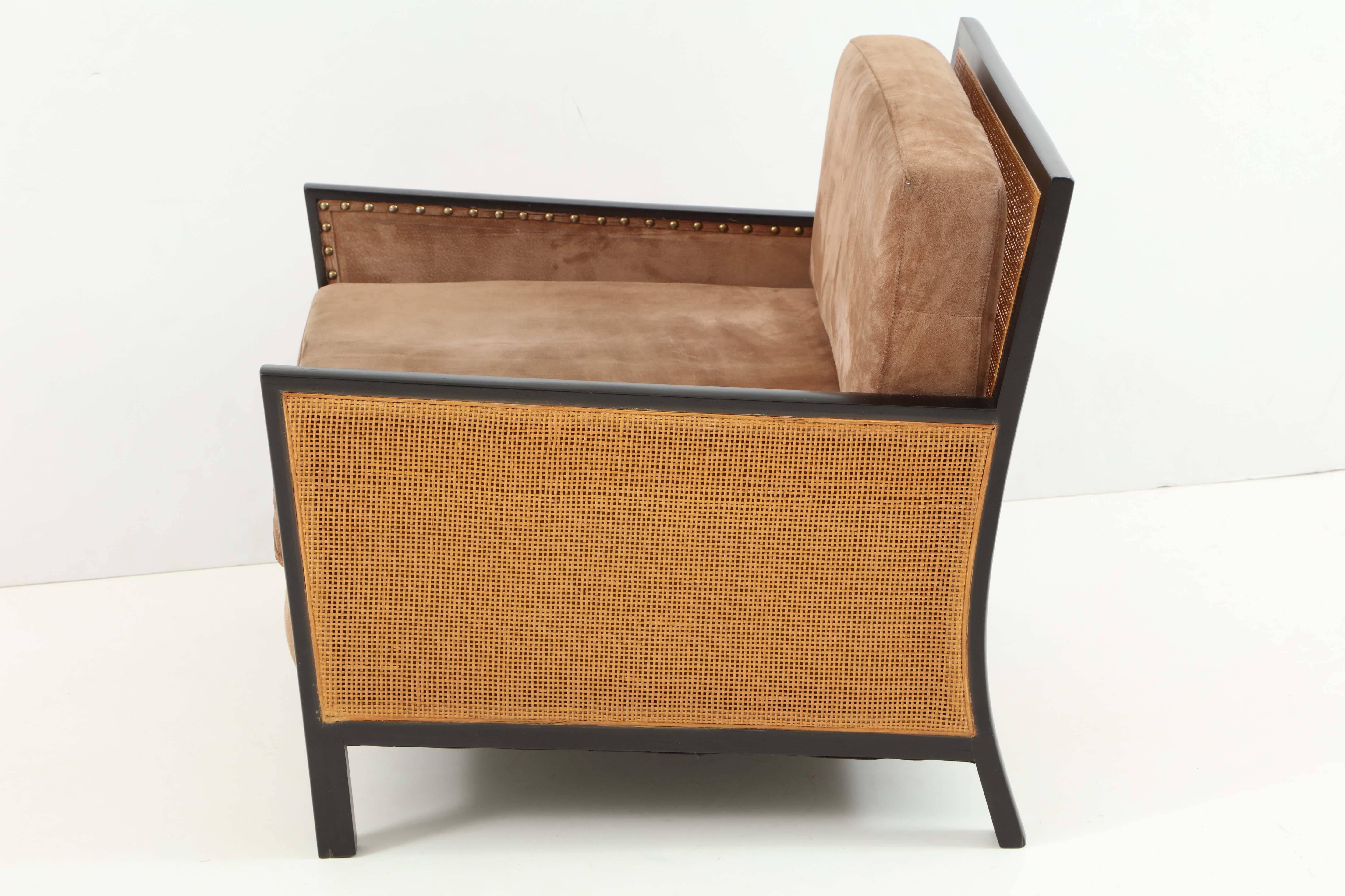 Pair of walnut lounge chairs, an early design by Milo Baughman for Arch Gordon, Chicago, 1955. Subtle play of angles and curves on the dark walnut frames, emphasized by the cane inserts on sides and back. Beautifully patinated split hide suede
