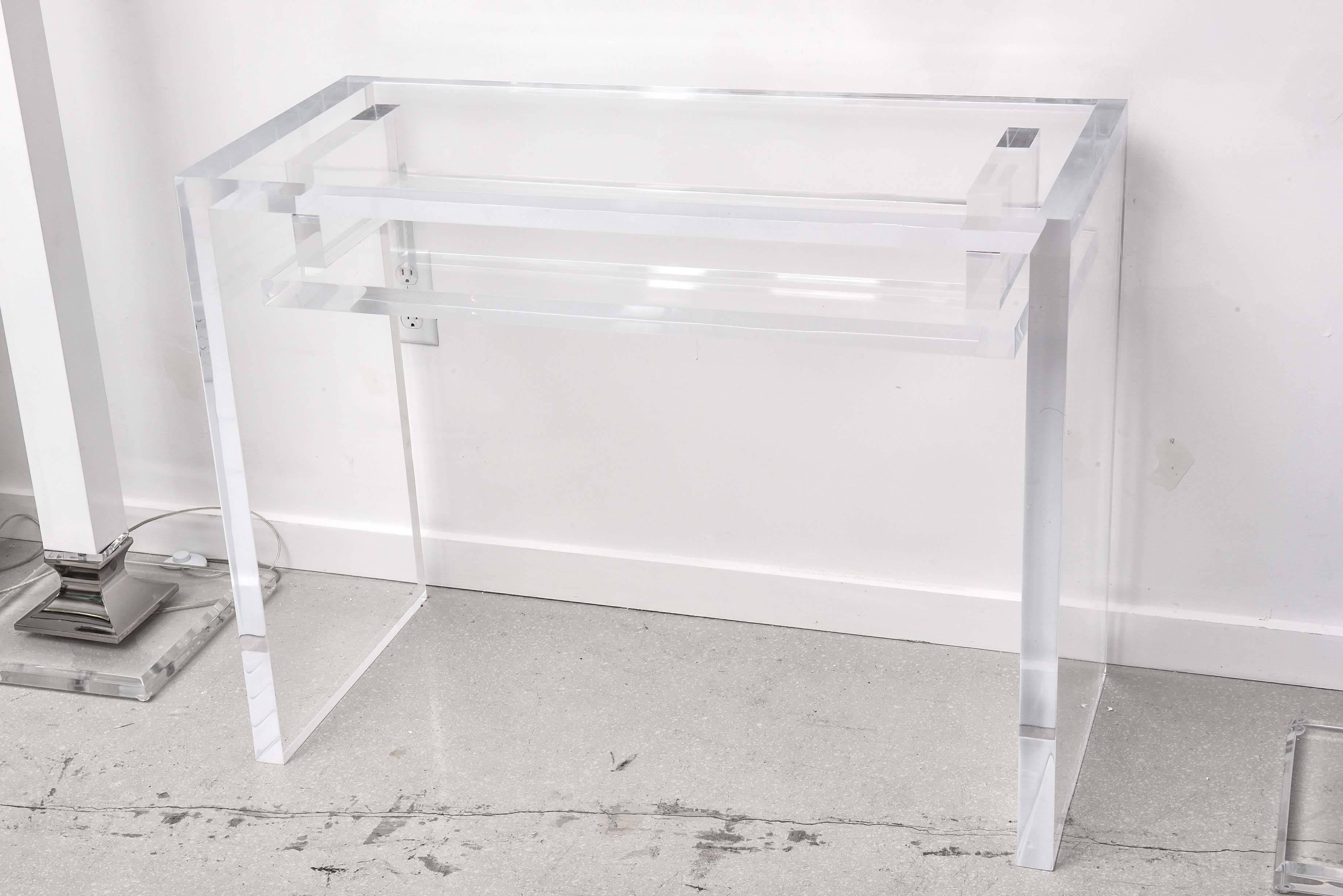 Lucite desk in the style of Charles Hollis Jones. The Lucite slabs which make up the desk are very thick- clear without fog or crazing.