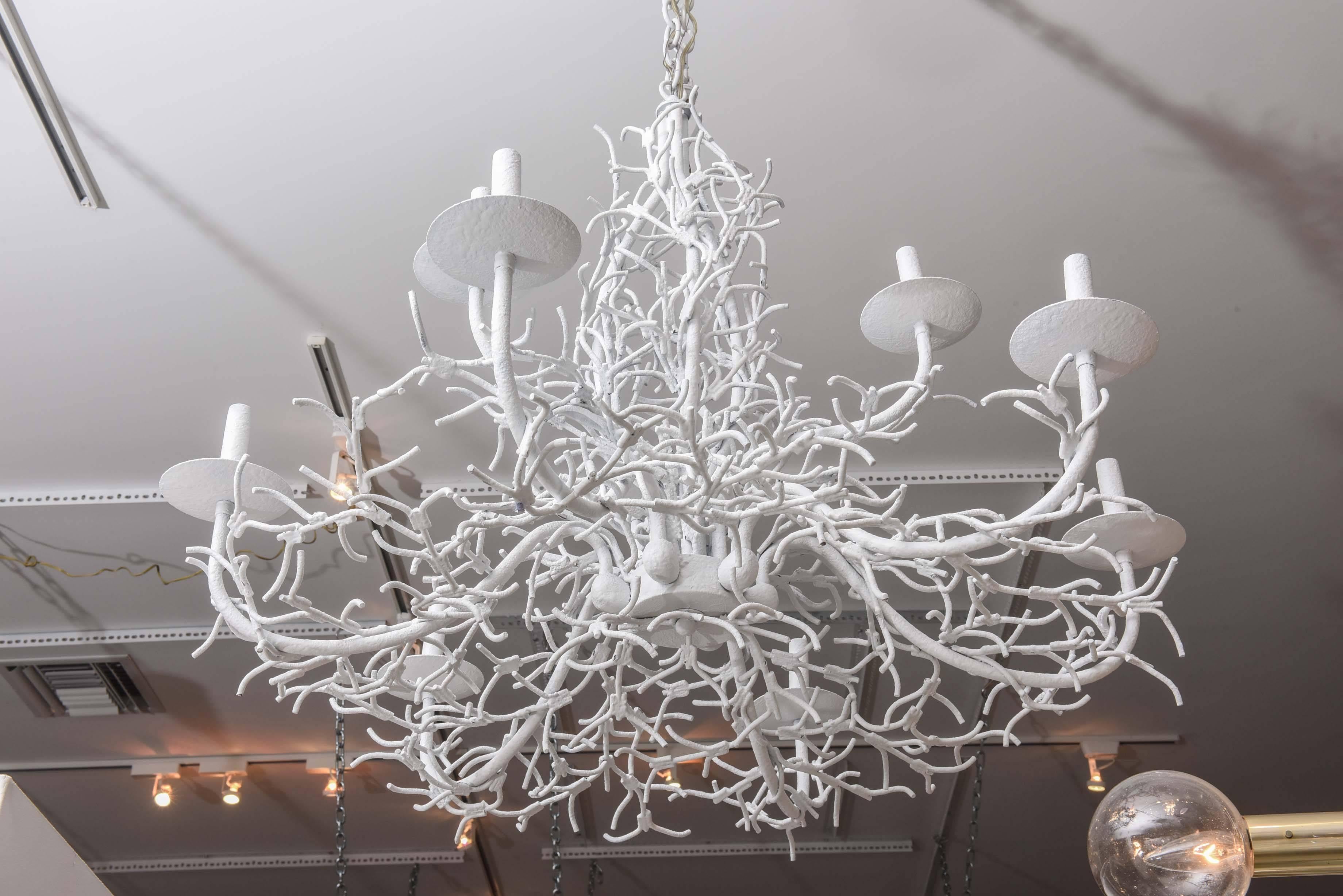 White lacquered iron chandelier with coral twig branches.