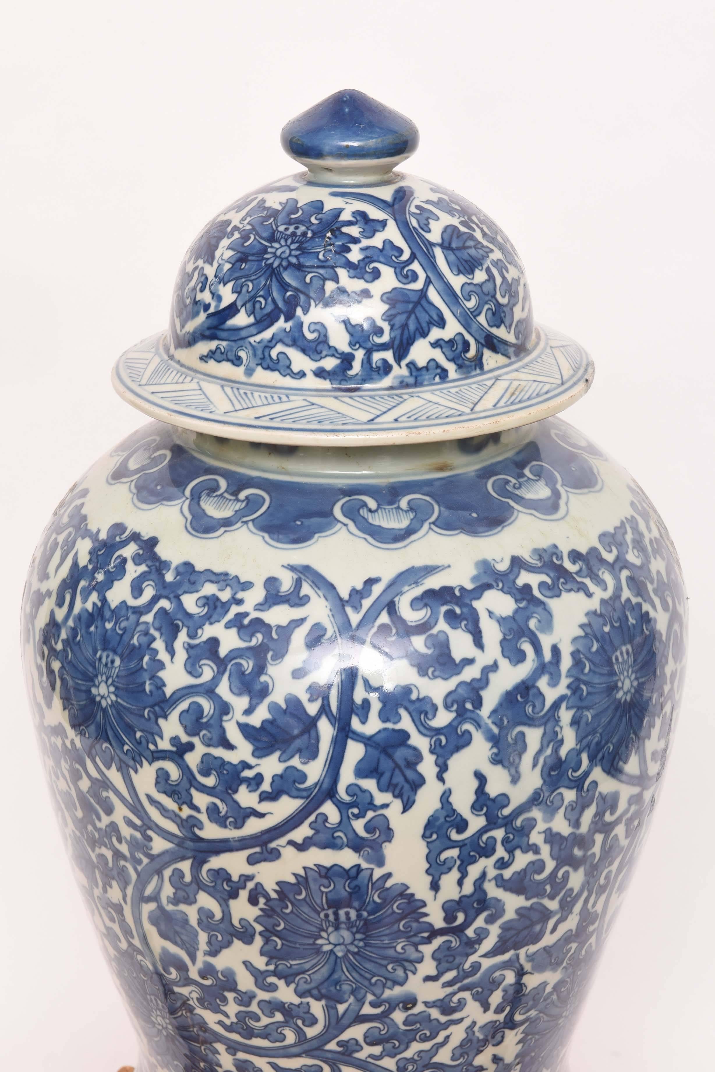 Striking large blue and white ginger jar with lid on gilded faux bamboo base.
