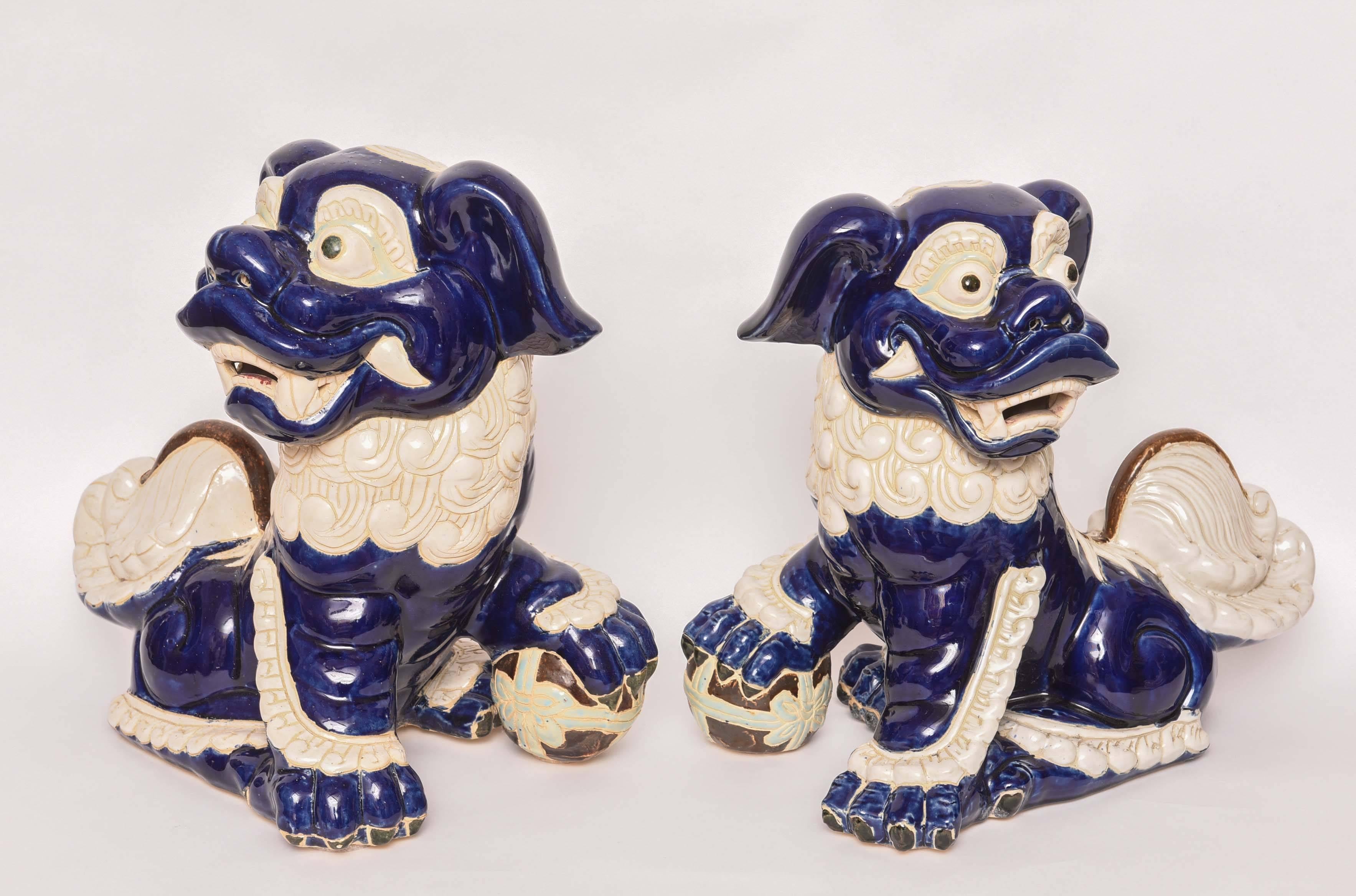 Large pair of vibrant blue and white seated Foo dogs.