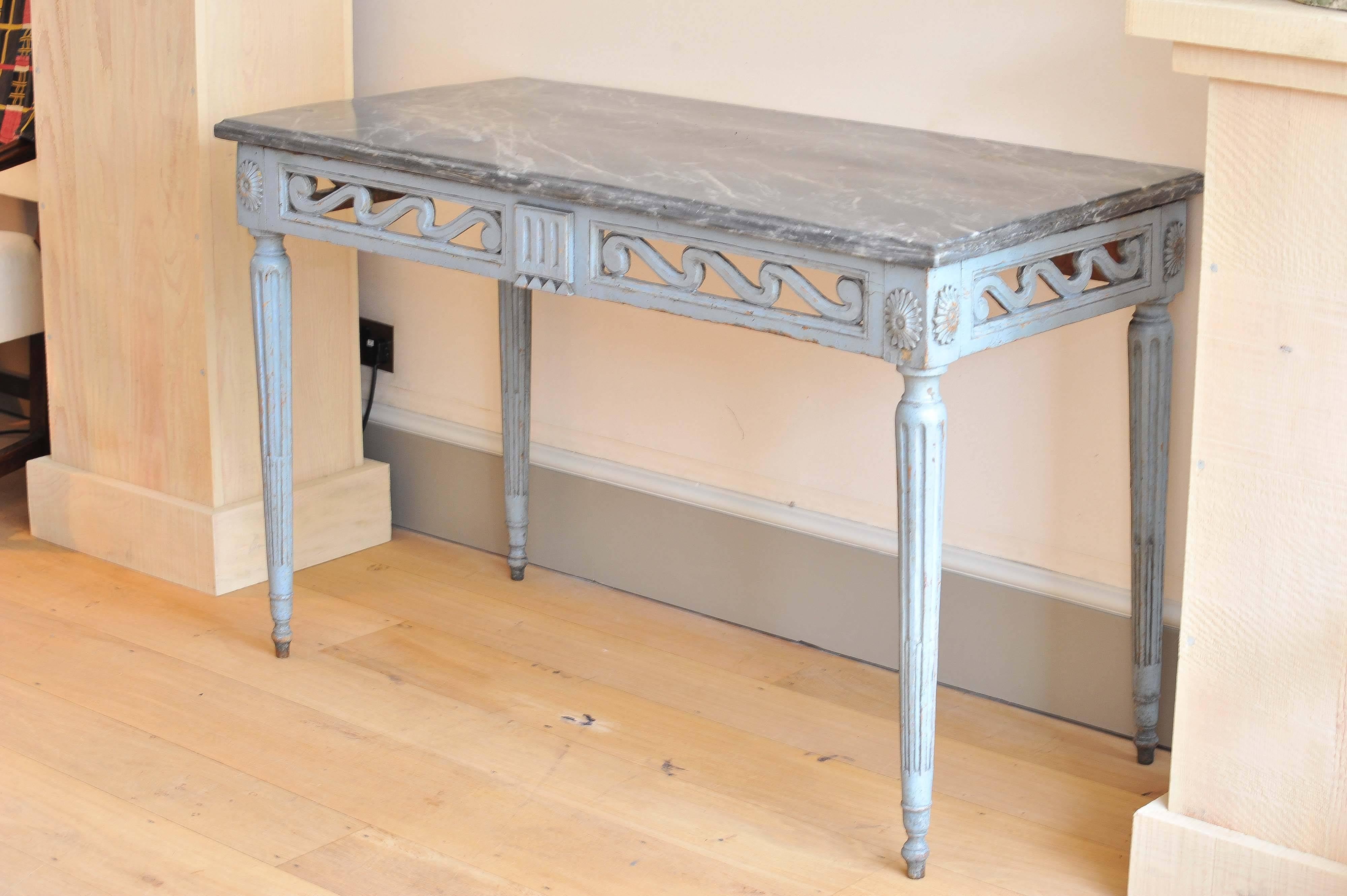 A late 18th century French provincial painted console table with shaped grey marble top above pierced frieze on columned leg terminating in ball feet.
Note: Retaining its original marble top.