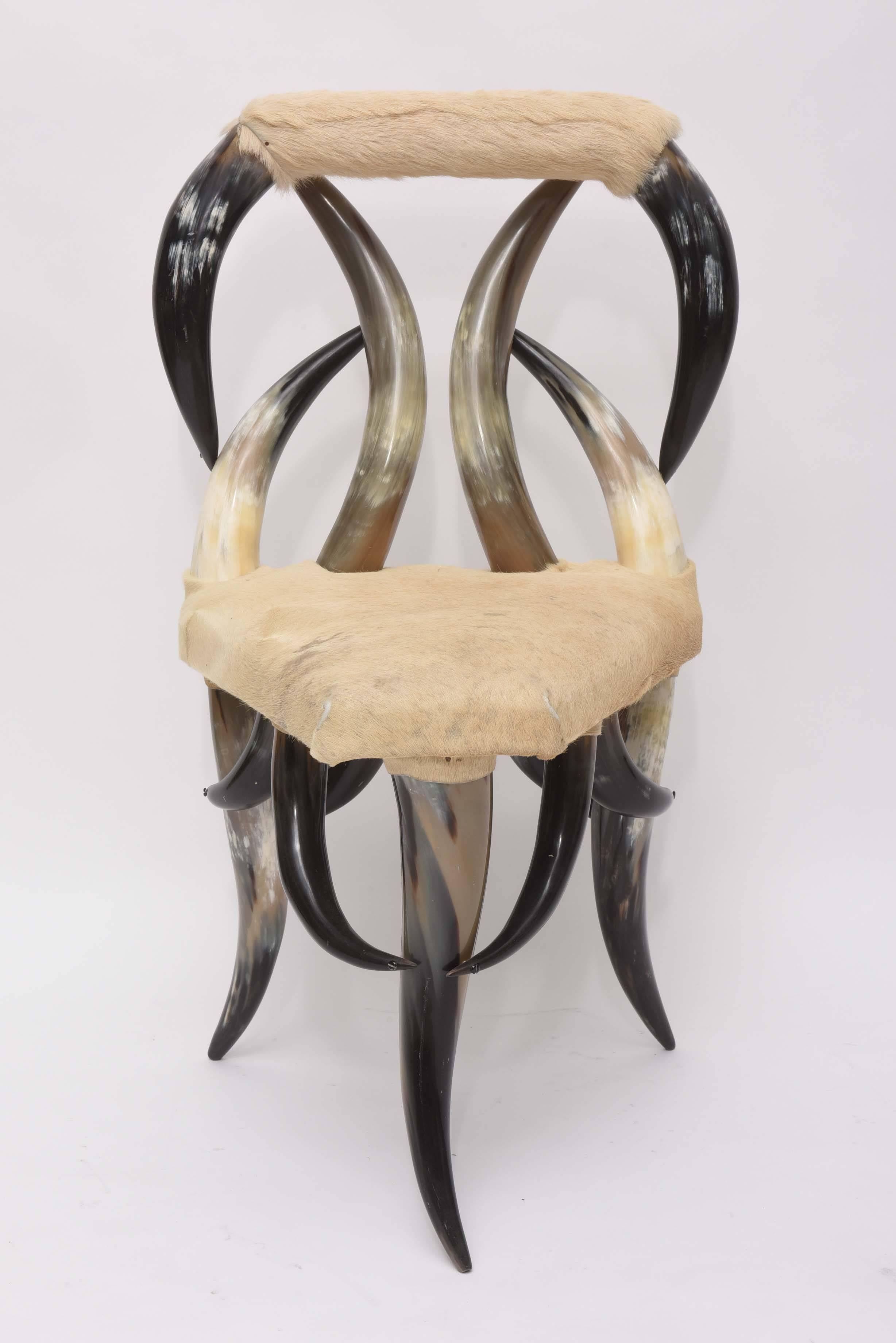 Vintage Horn chair with original buff cowhide upholstery.