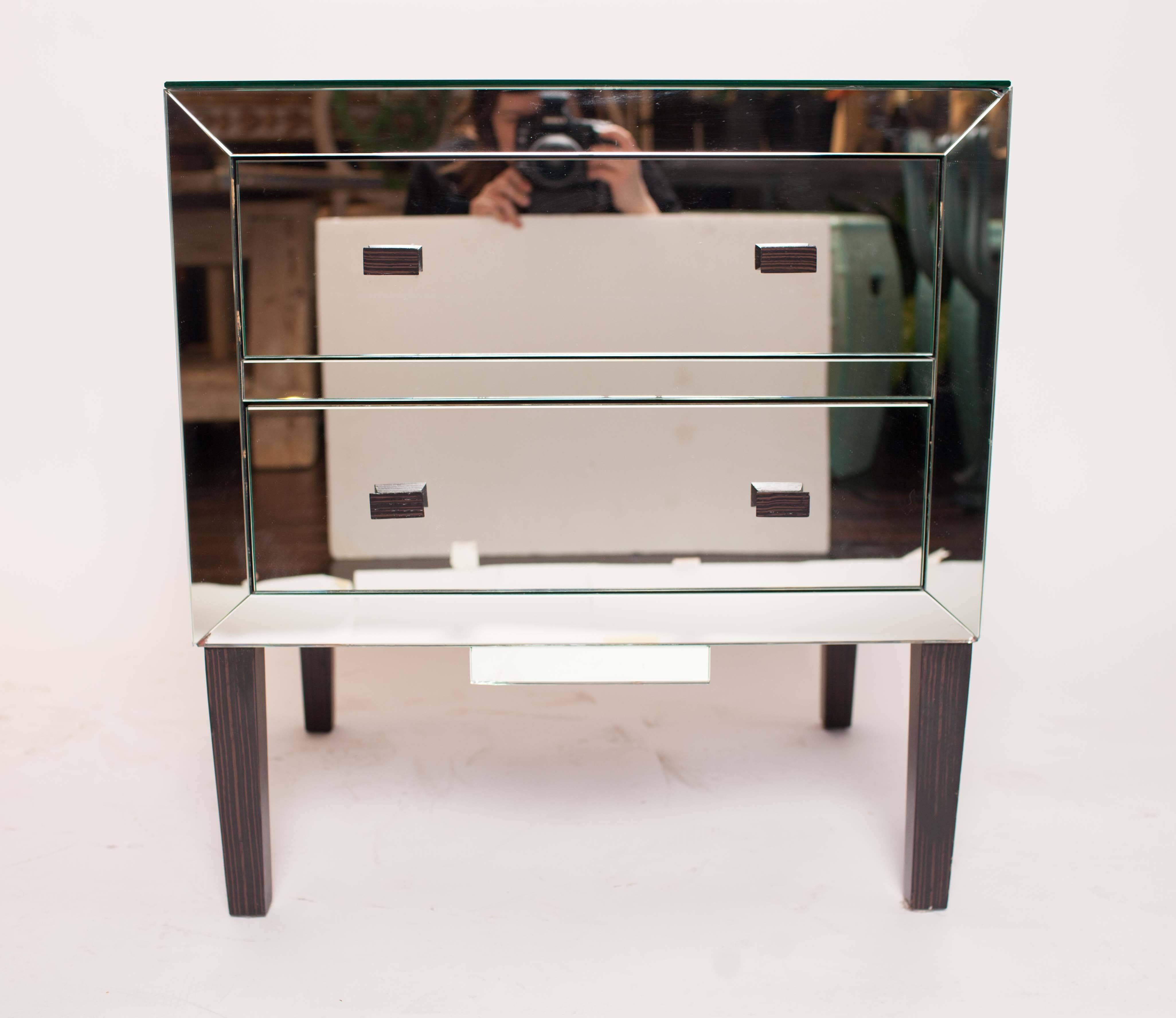 Side tables are mirrored on three sides and on top and have two drawers.  Mirrored panels meet with beveled edges. Wood pulls and legs.  