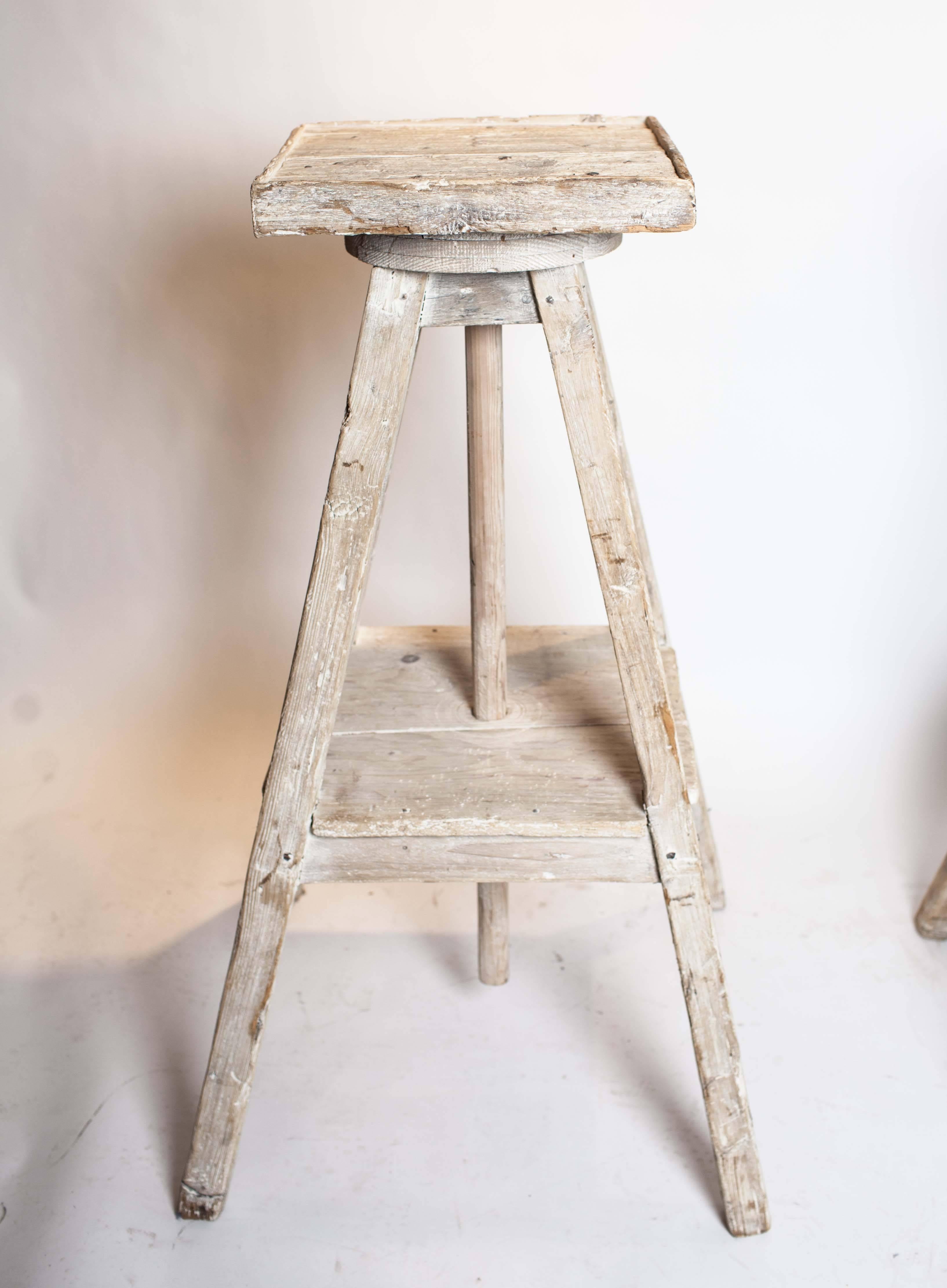 Bleached wood sculptor's pedestals have rotating square tops.