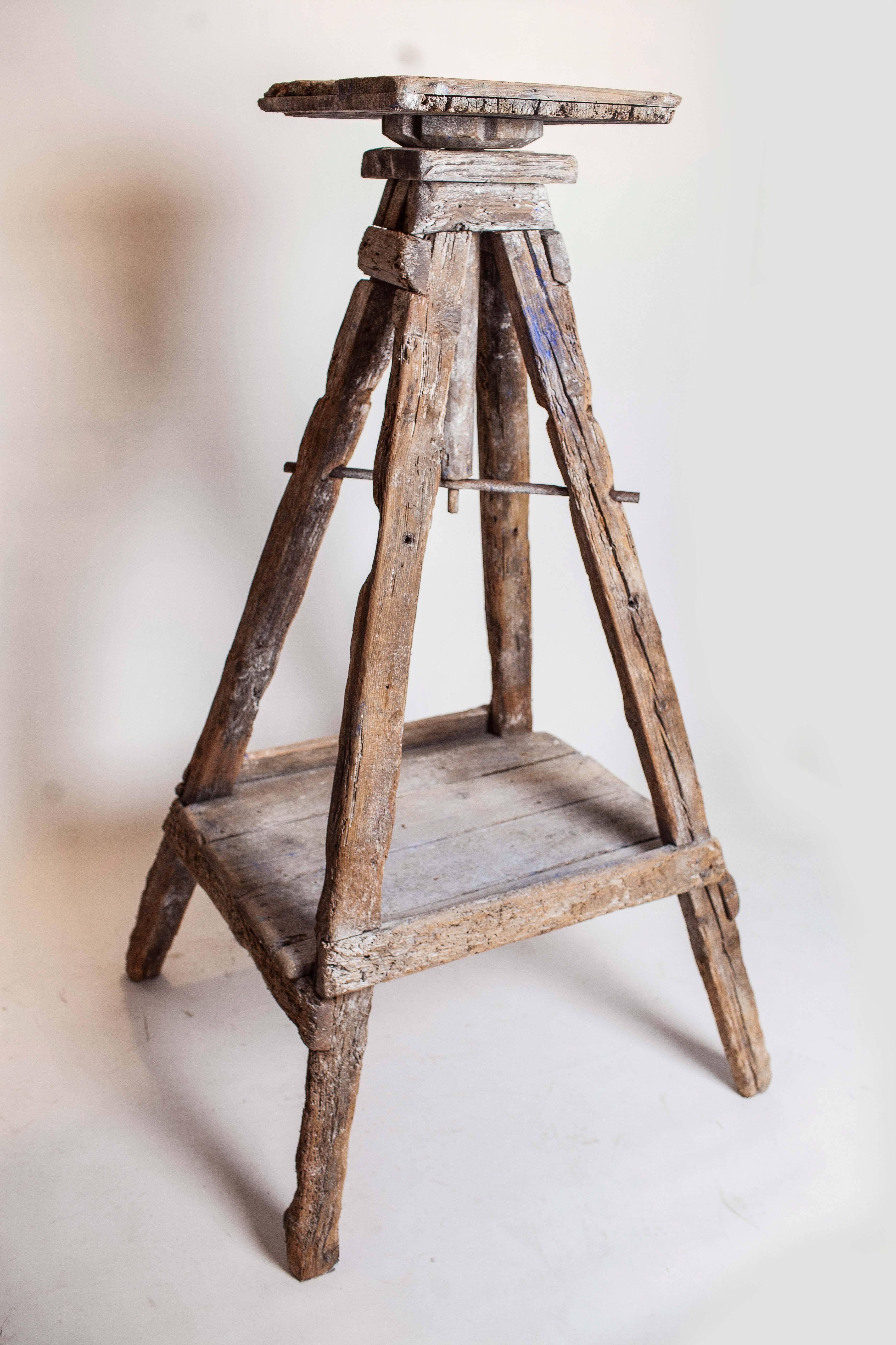 Tall, rustic sculptor's stand with square rotating top.  