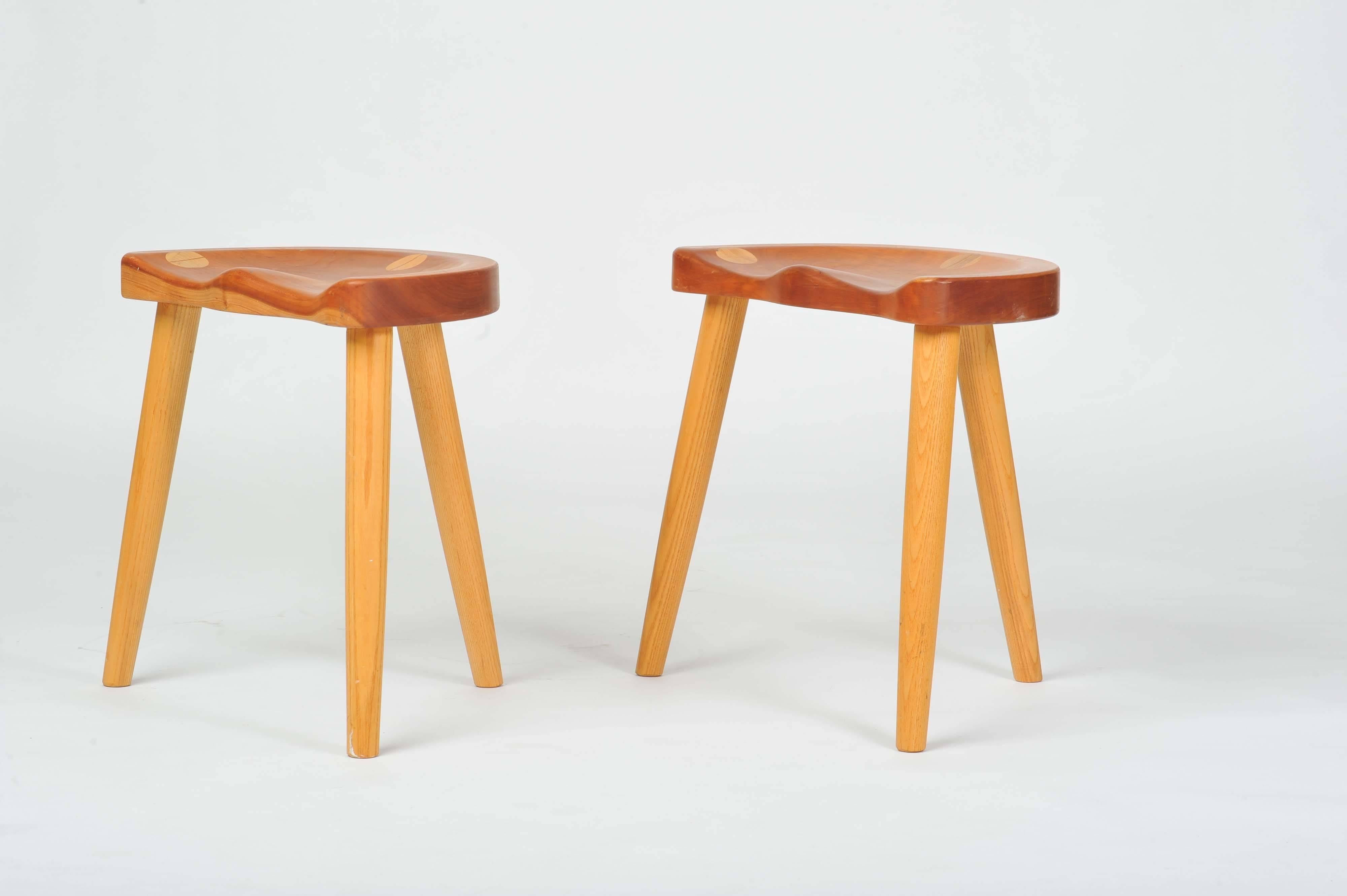 These curvaceous hand-sculpted blond wooden stools have an unusual construction. The legs are inserted into the seat and become a design feature.
 