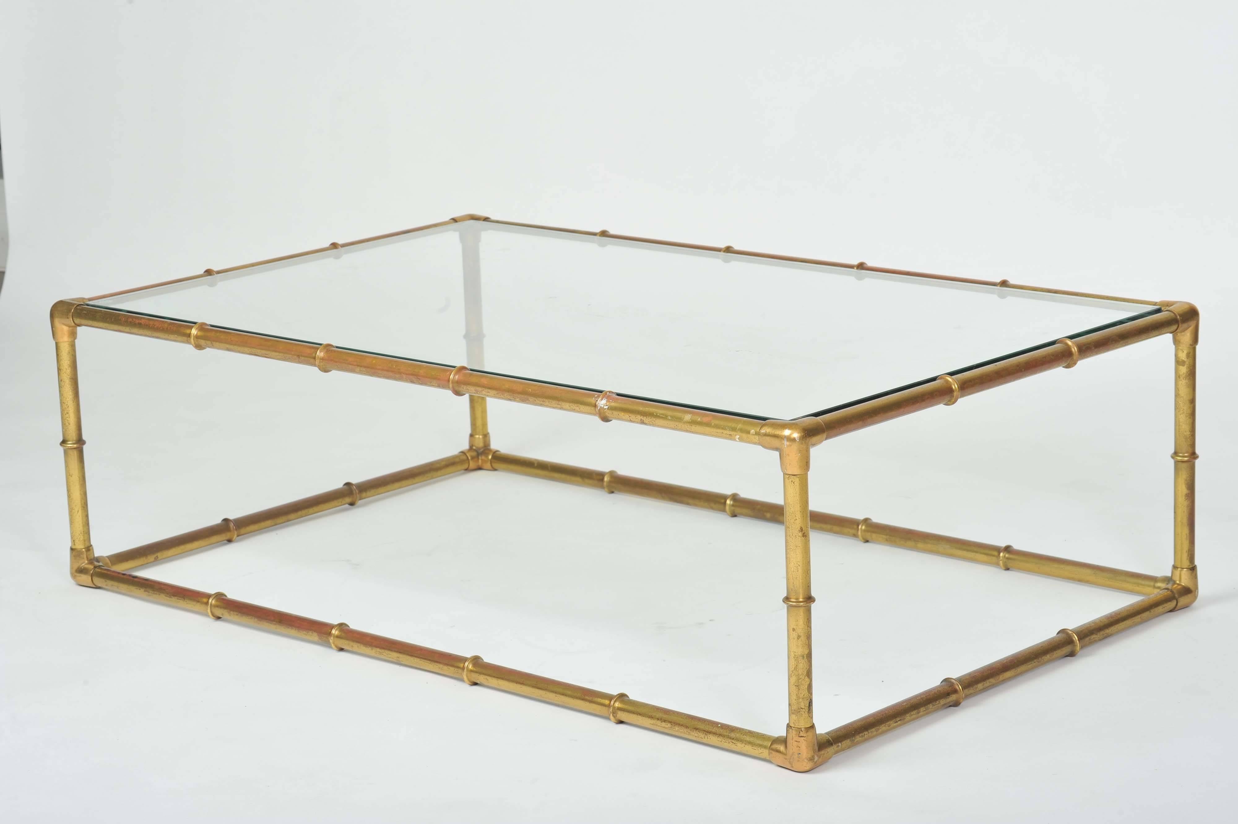 Bamboo effect lounge table frame is made of brass-plated copper and has a natural patina of age. The inset glass top is toughened.


