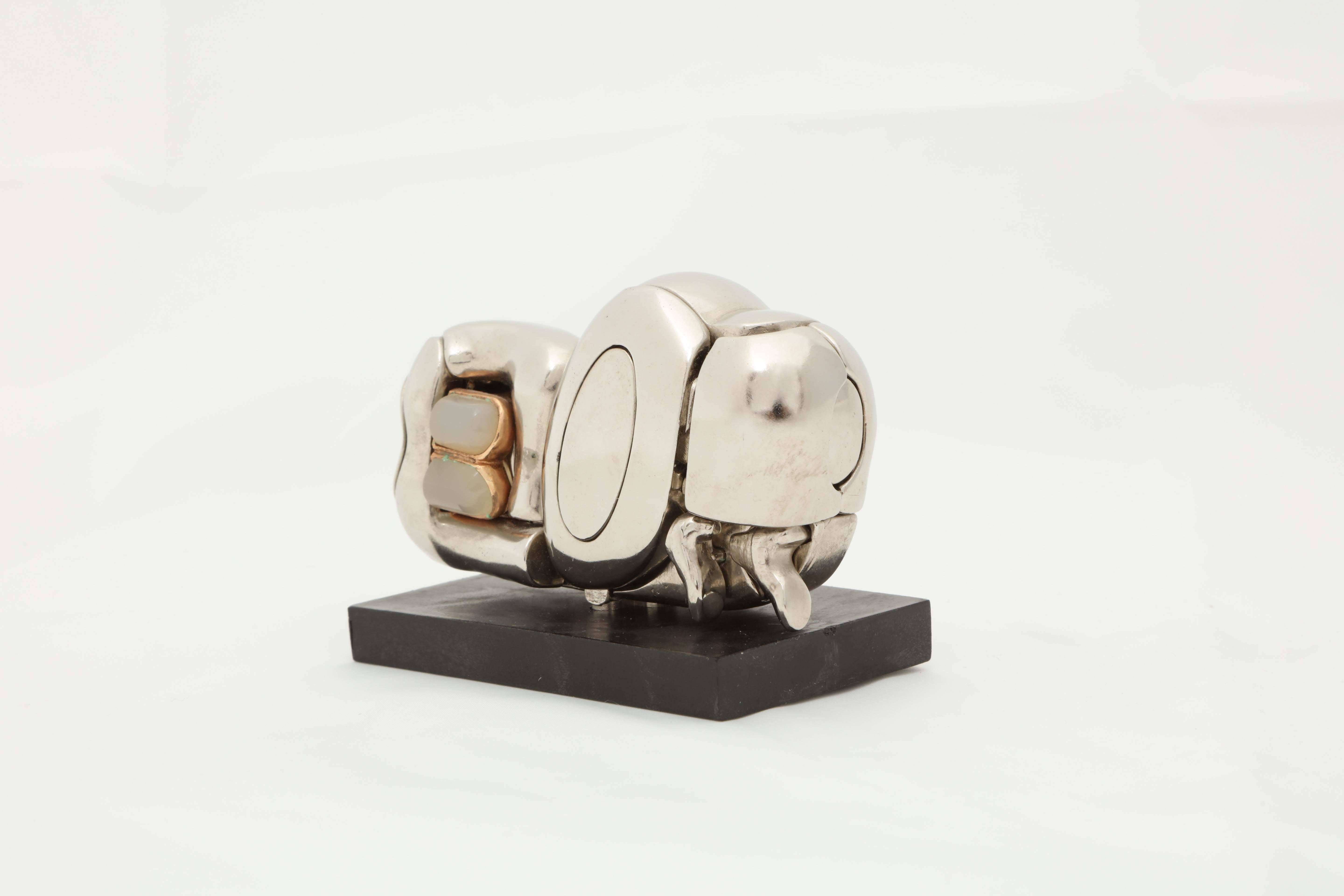 A nickel-plated puzzle sculpture consisting of 23 elements, the model is Berrocal's Homage to Paloma Picasso. The model is signed Berrocal and is 
numbered 3243. It is sold with the accompanying book also numbered 3243.
It's in mint condition.