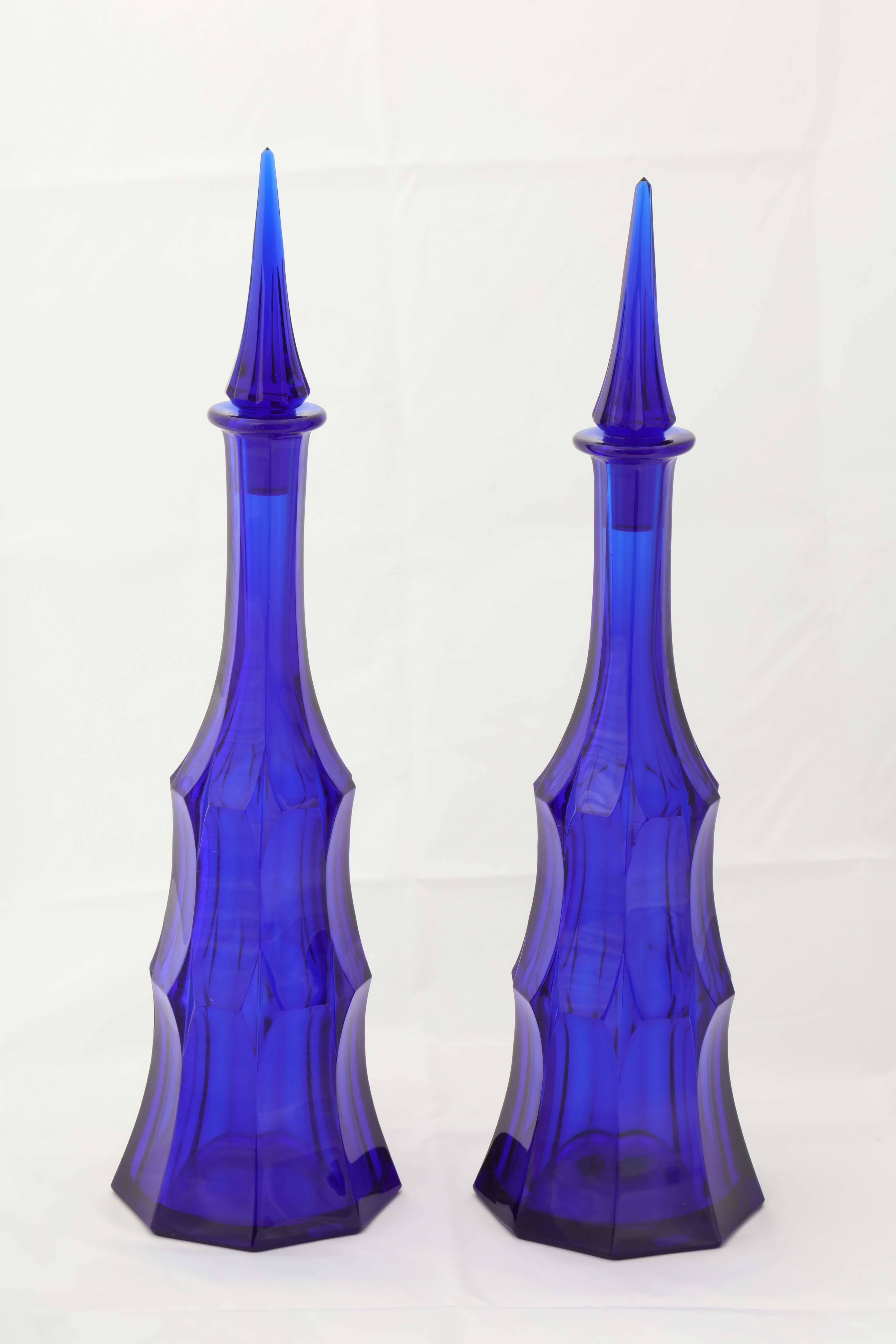 A pair of cobalt blue wheel carved decanters by Moser, circa 1918. 
Etched made in Czechoslovakia, Moser, Karlsbad, mint condition.
One decanter 17.5 inches high, the other 17.88 inches high.
 