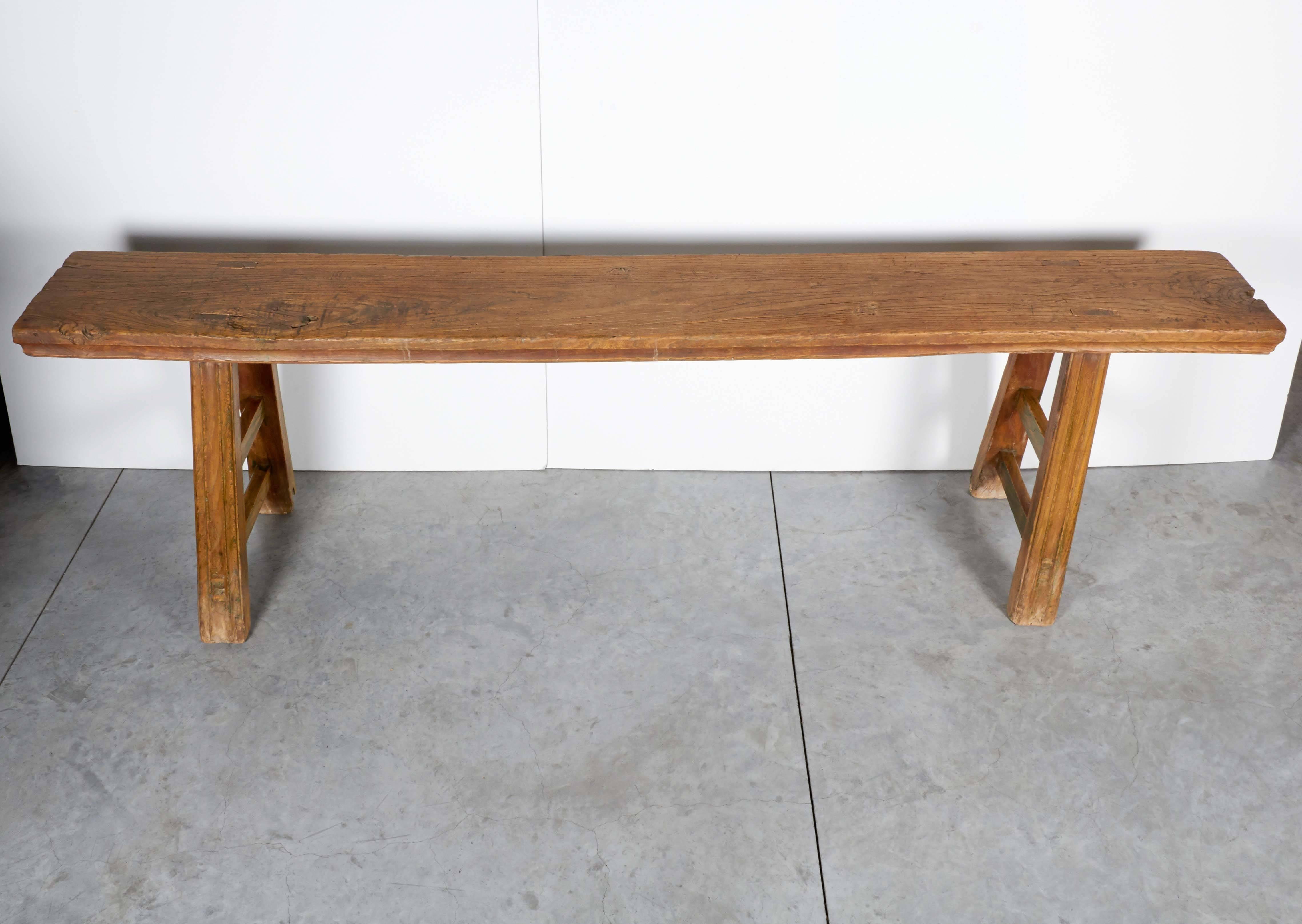 A tall country bench with a solid top made of a single piece of two and half inch thick elm wood. From Shandong Province, circa 1880.

BN333.