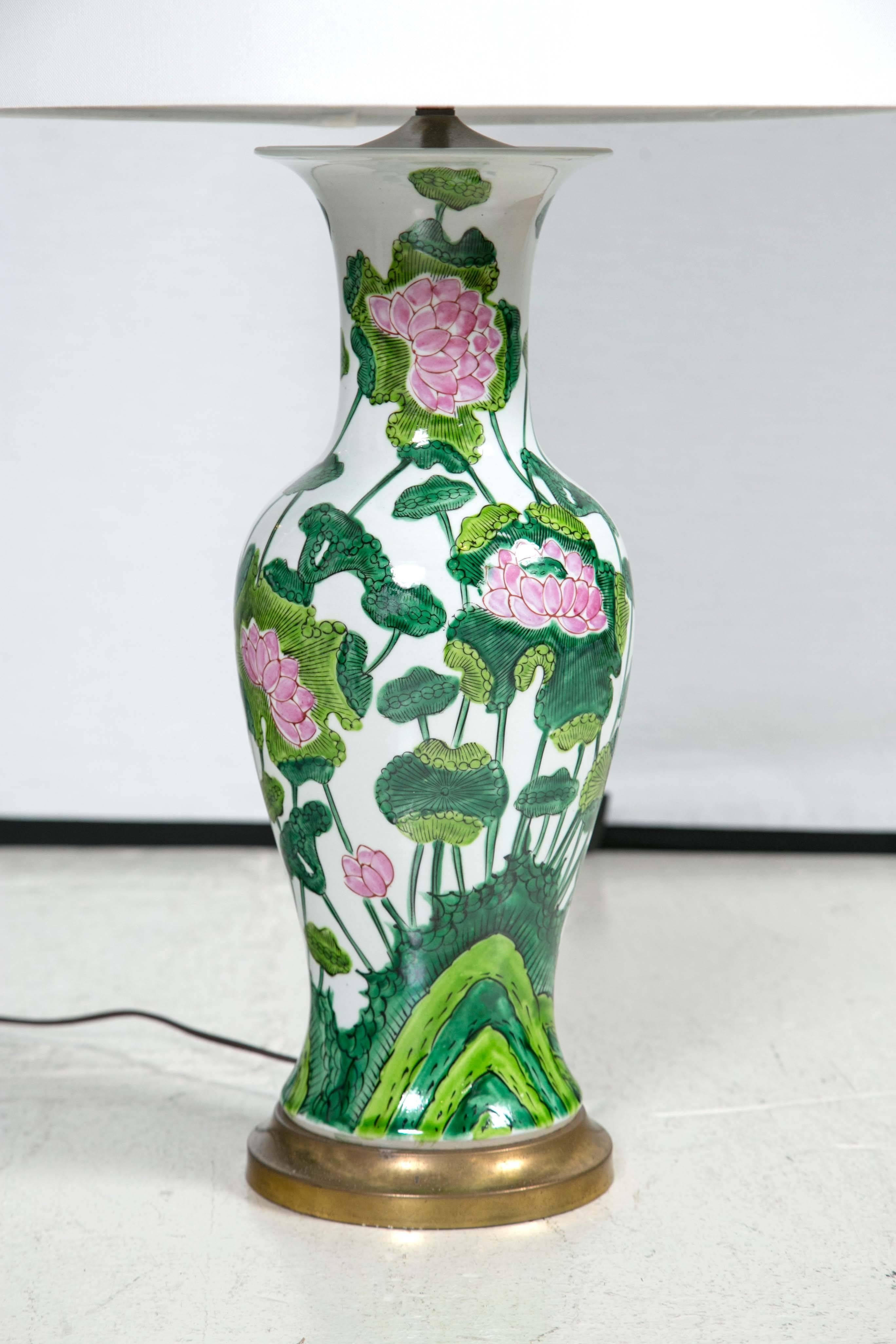 Tall ceramic lamps in white glaze, with pink and green water lilies. Shades are included.