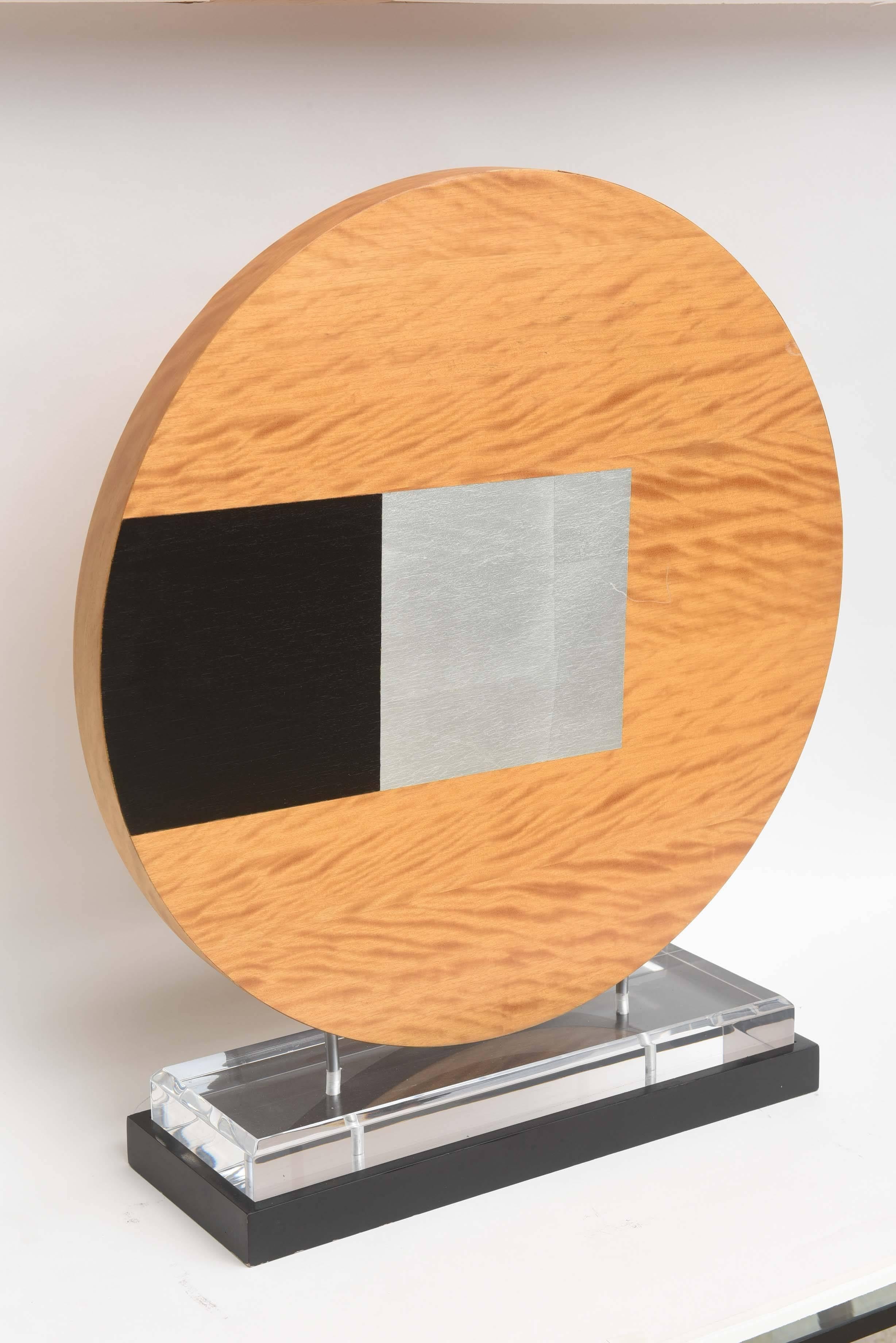 circular wood with enonized and silver gilt on lucite stand
