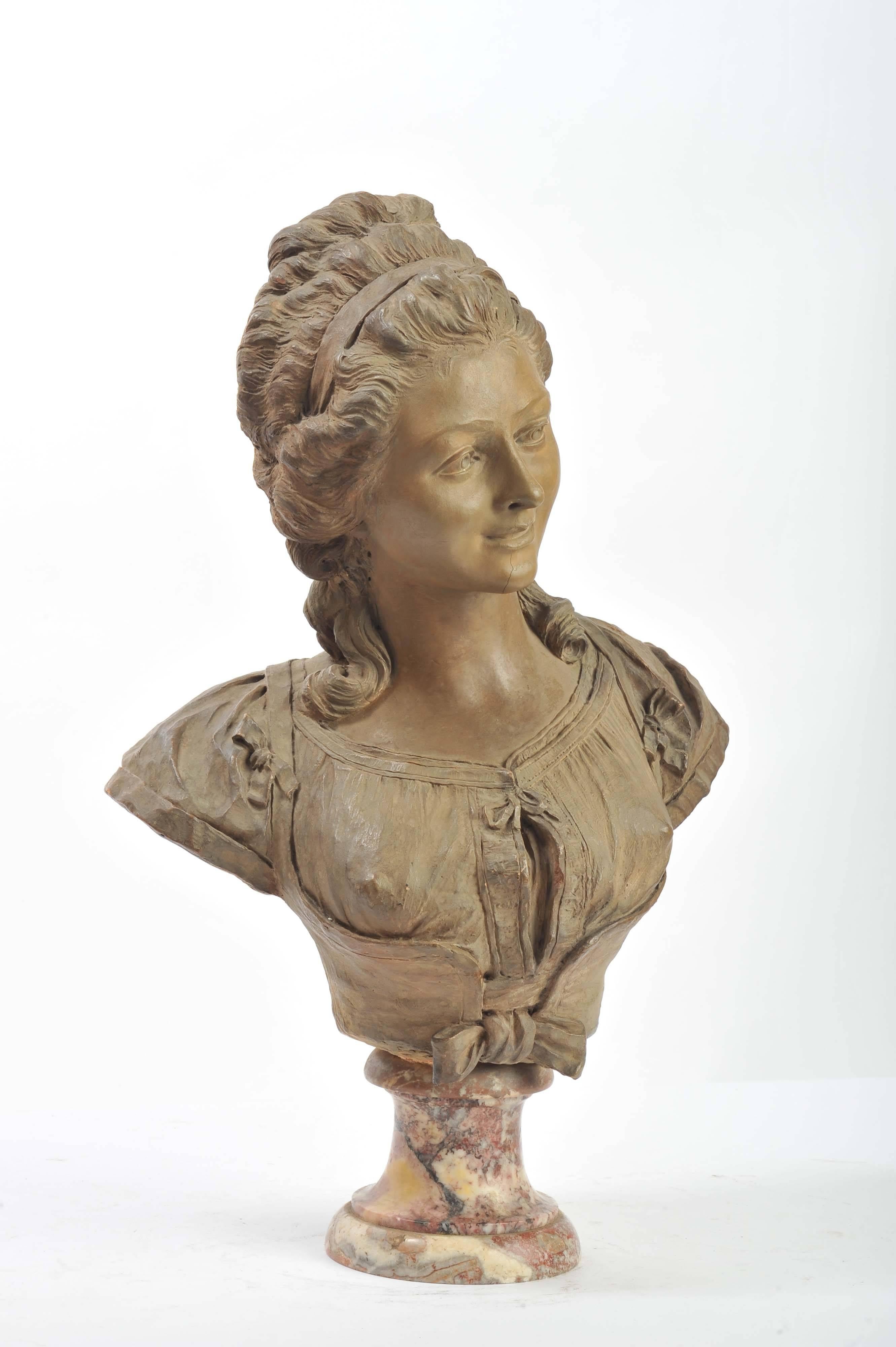 A good quality French 19th patinated terracotta bust of a classical lady, mounted on a Rouge marble sockel.