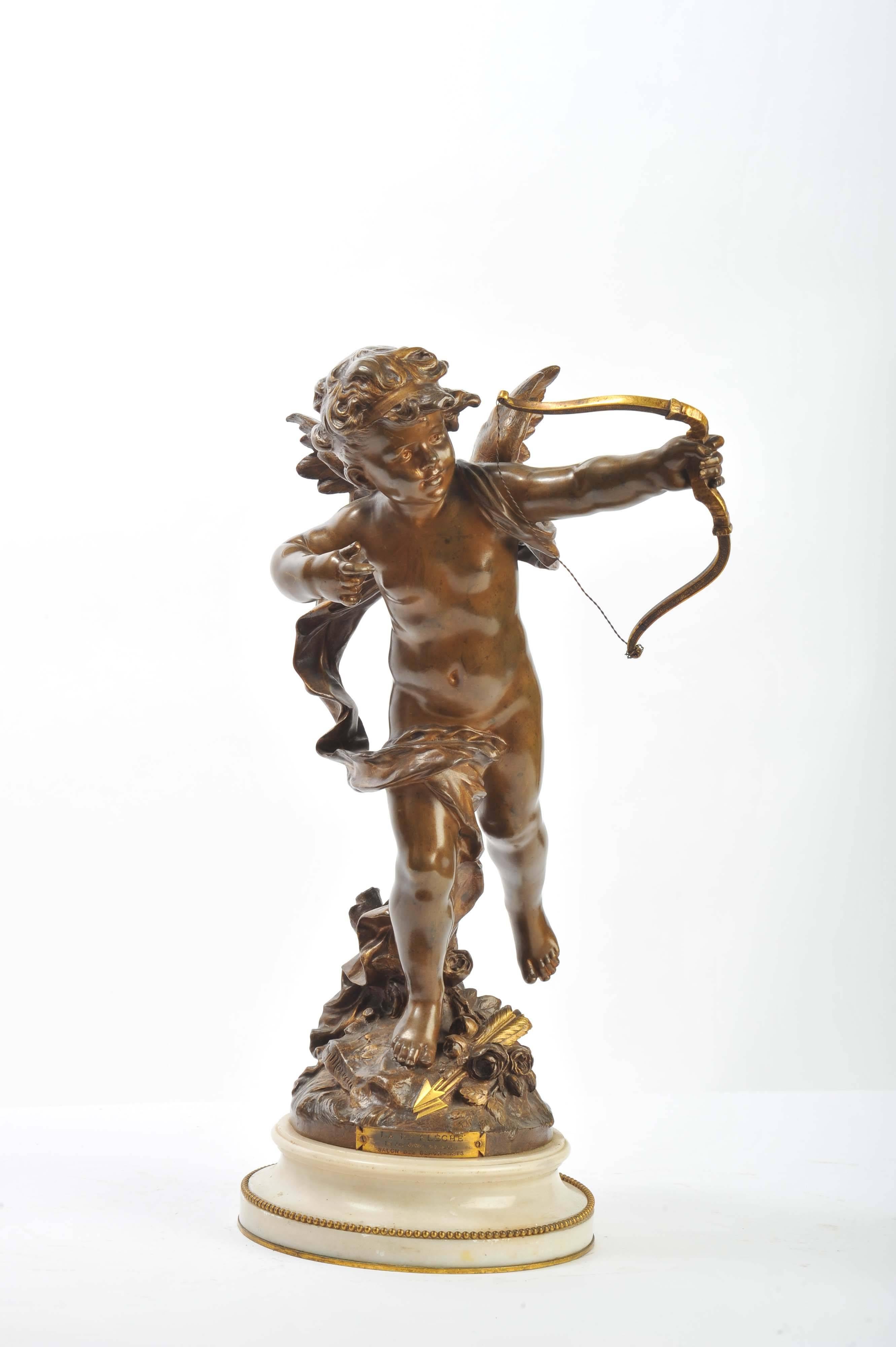 A fine quality 19th century bronze statue of a Cupid, with gilded high lights and mounted on a white marble base.