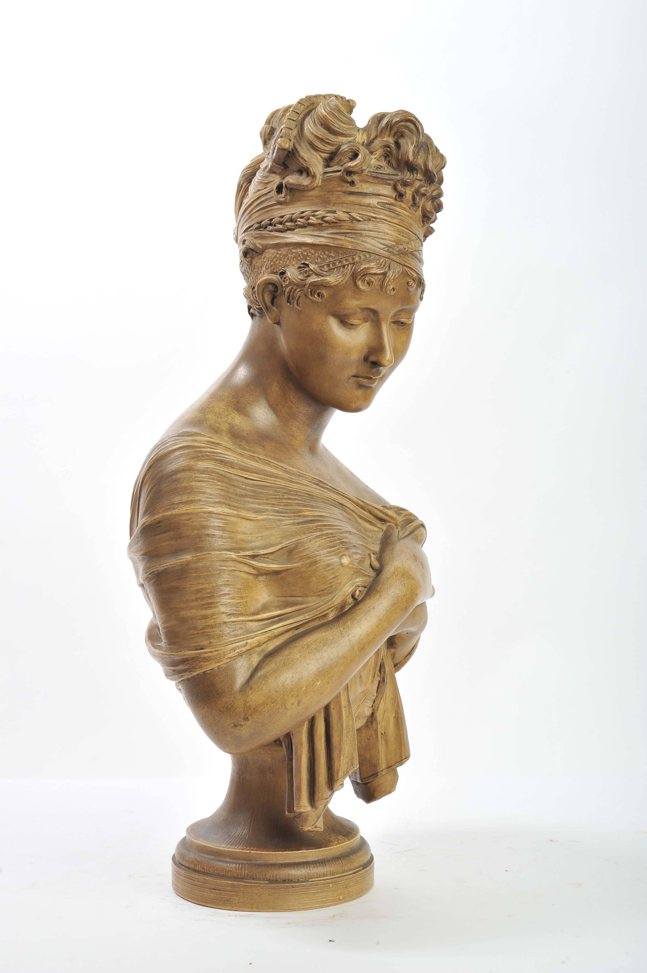 A very pleasing French 19th century terracotta bust of a girl with a head and shoulder scarf.