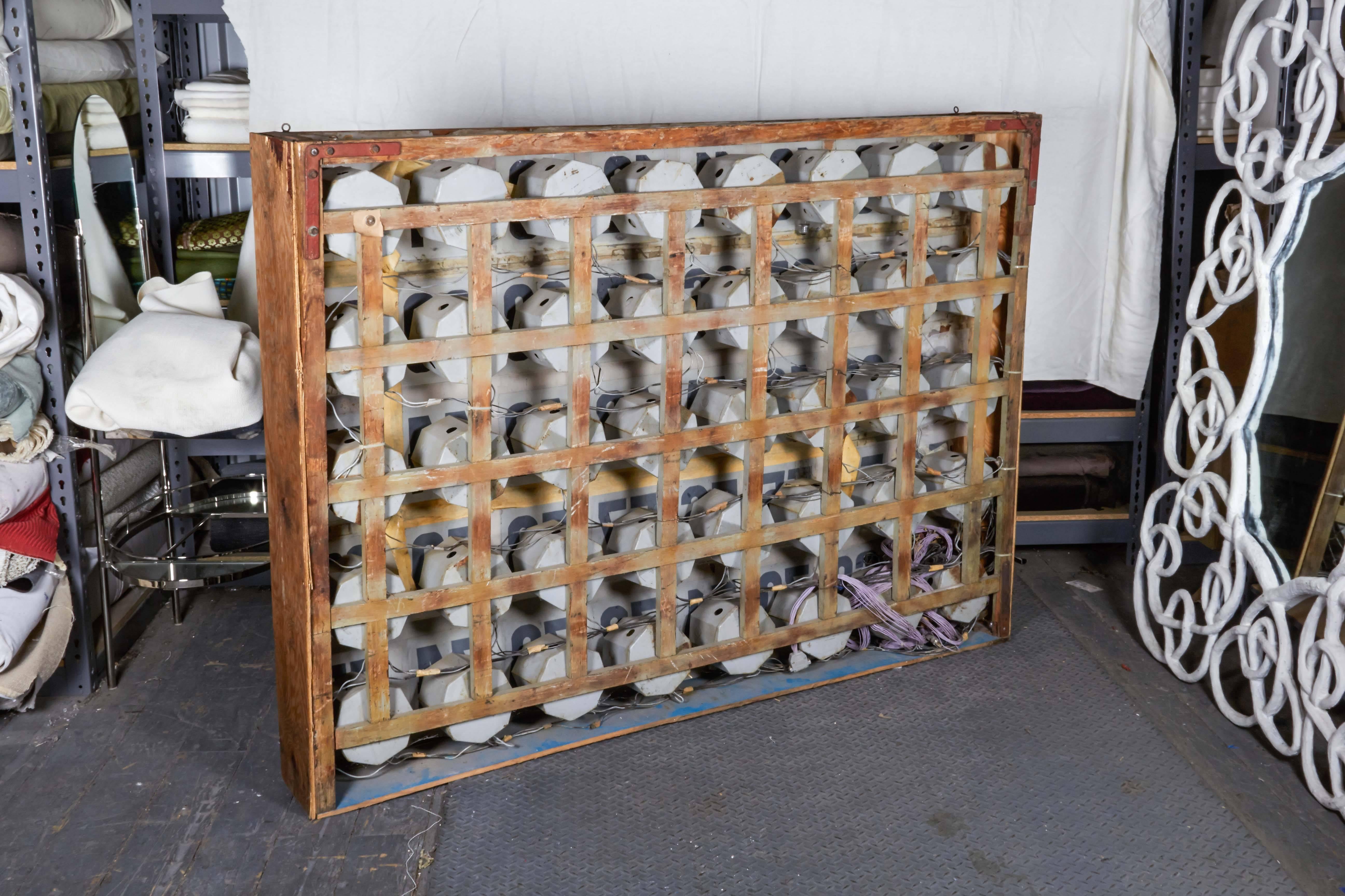 Large-scale BINGO call board, featuring hand-painted numbers on vellum. Originally designed to be back-lit, this unique piece of American Folk Art includes original wiring.