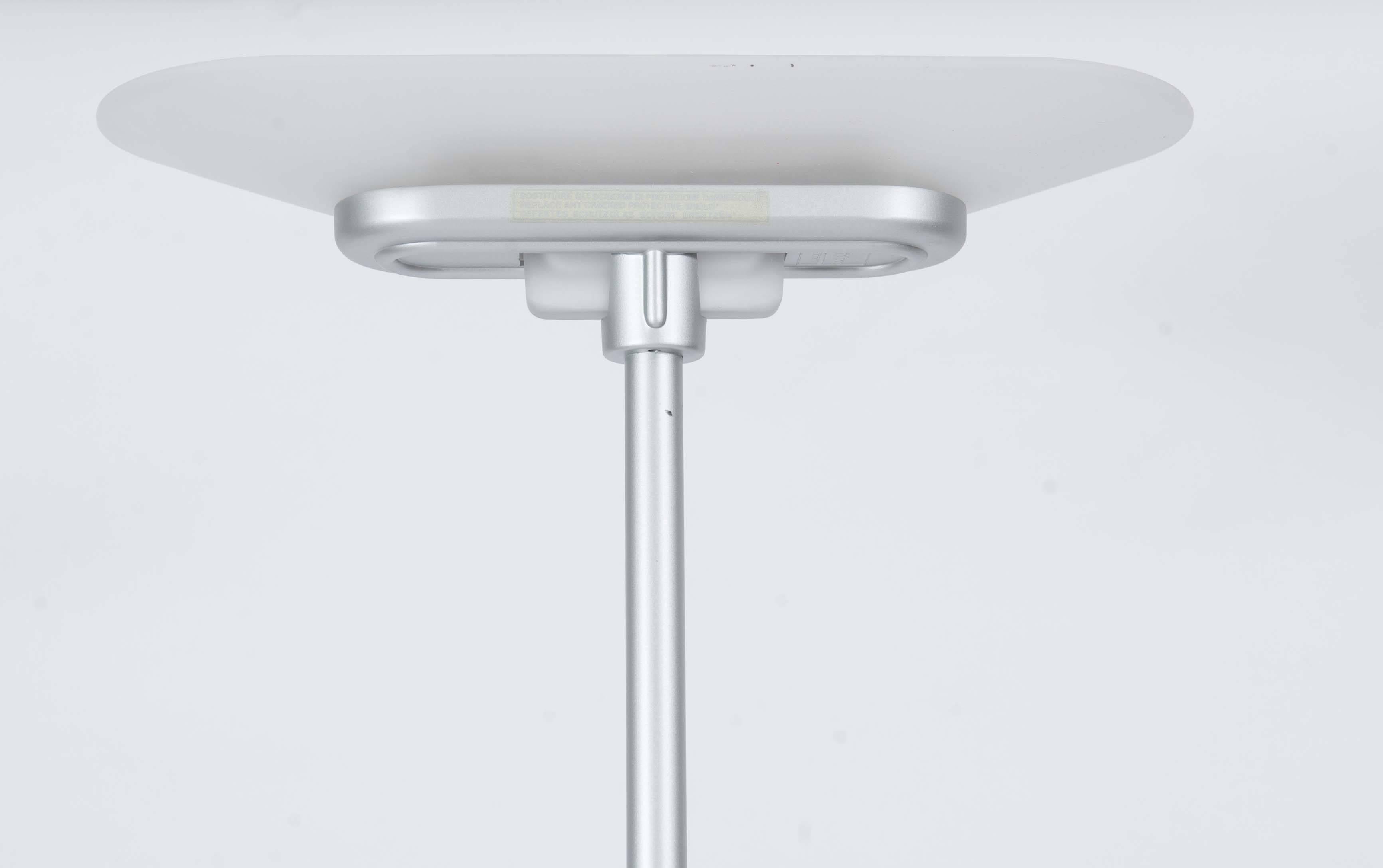 This very elegantly shaped Italian design lamp was the result of cooperation in 1978 of a trio of designers. 
The shade and foot are both made of white frosted glass; the tube is made of stainless steel. 
A good functioning dimmer with separate on