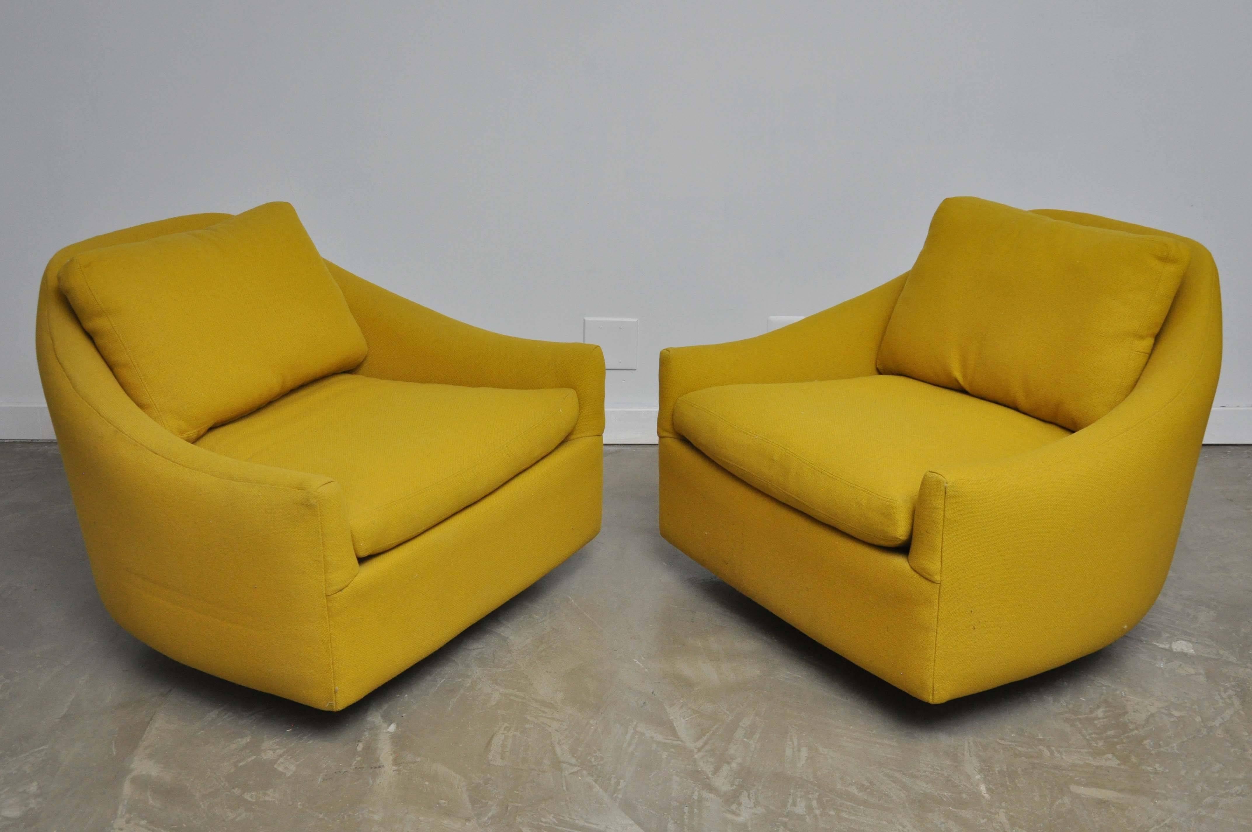 Pair of swivel chairs by Milo Baughman. Original wool upholstery over refinished walnut bases.