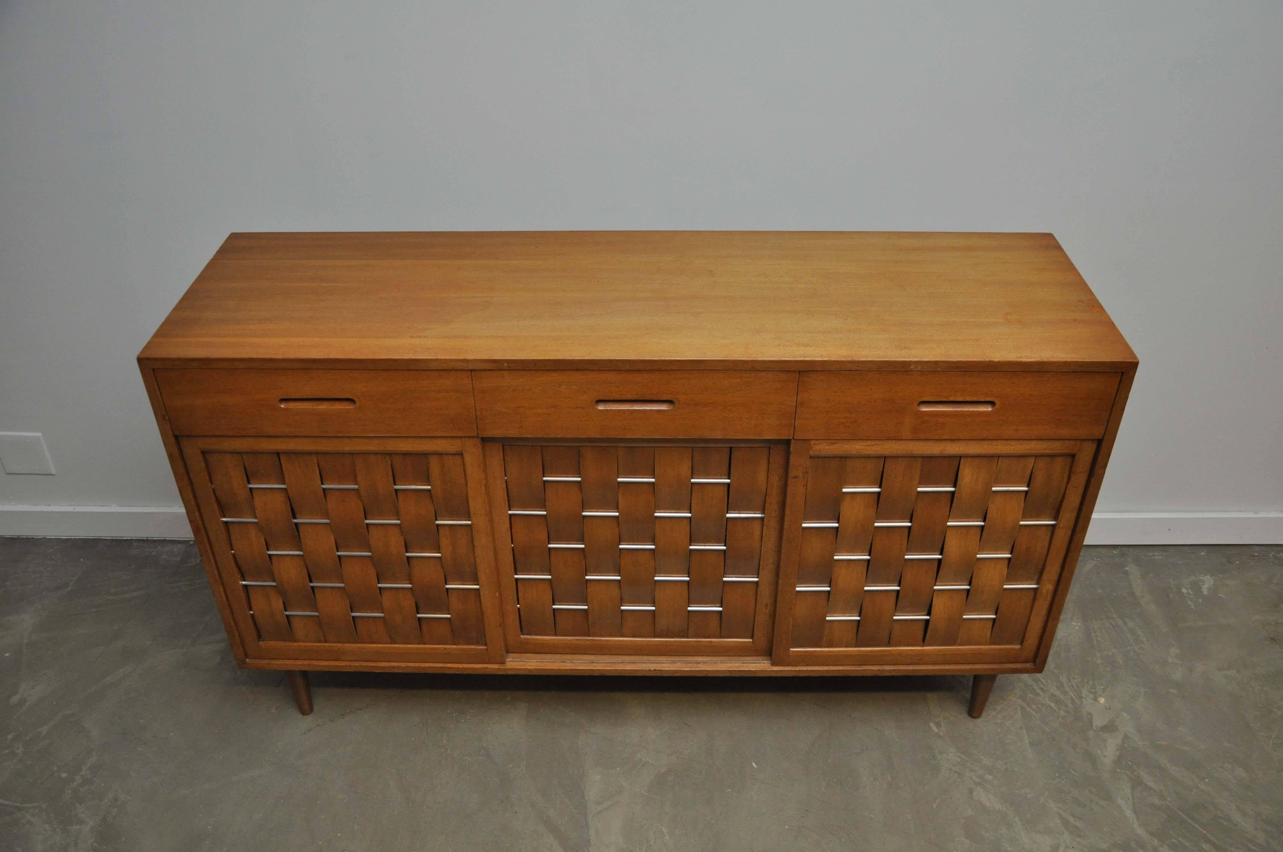 Mahogany woven front sideboard with nickel accent rods. Designed by Edward Wormley for Dunbar, circa 1950s.