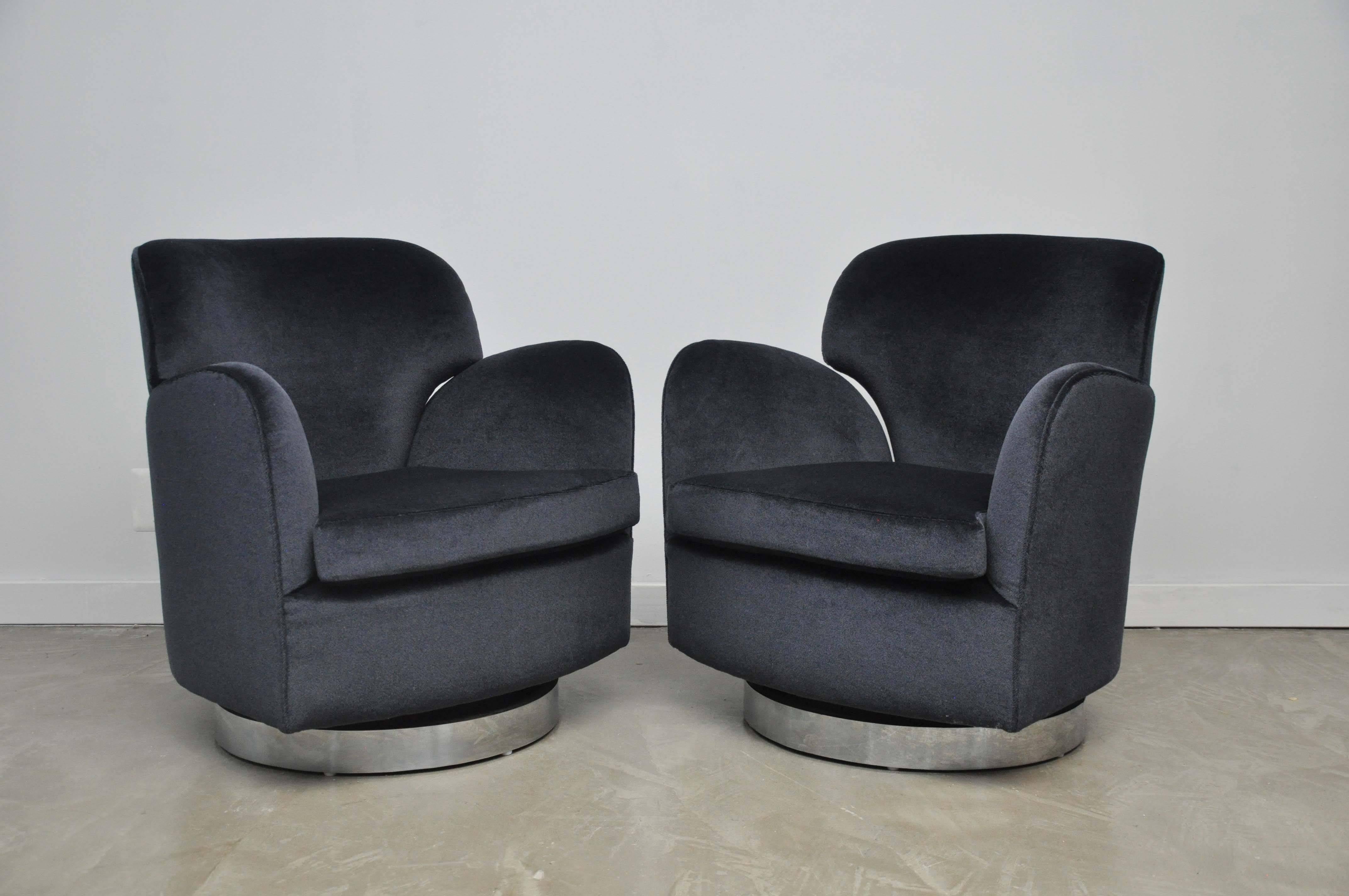 Milo Baughman swivel chairs with recline backs. Newly upholstered in charcoal mohair over chrome bases.
