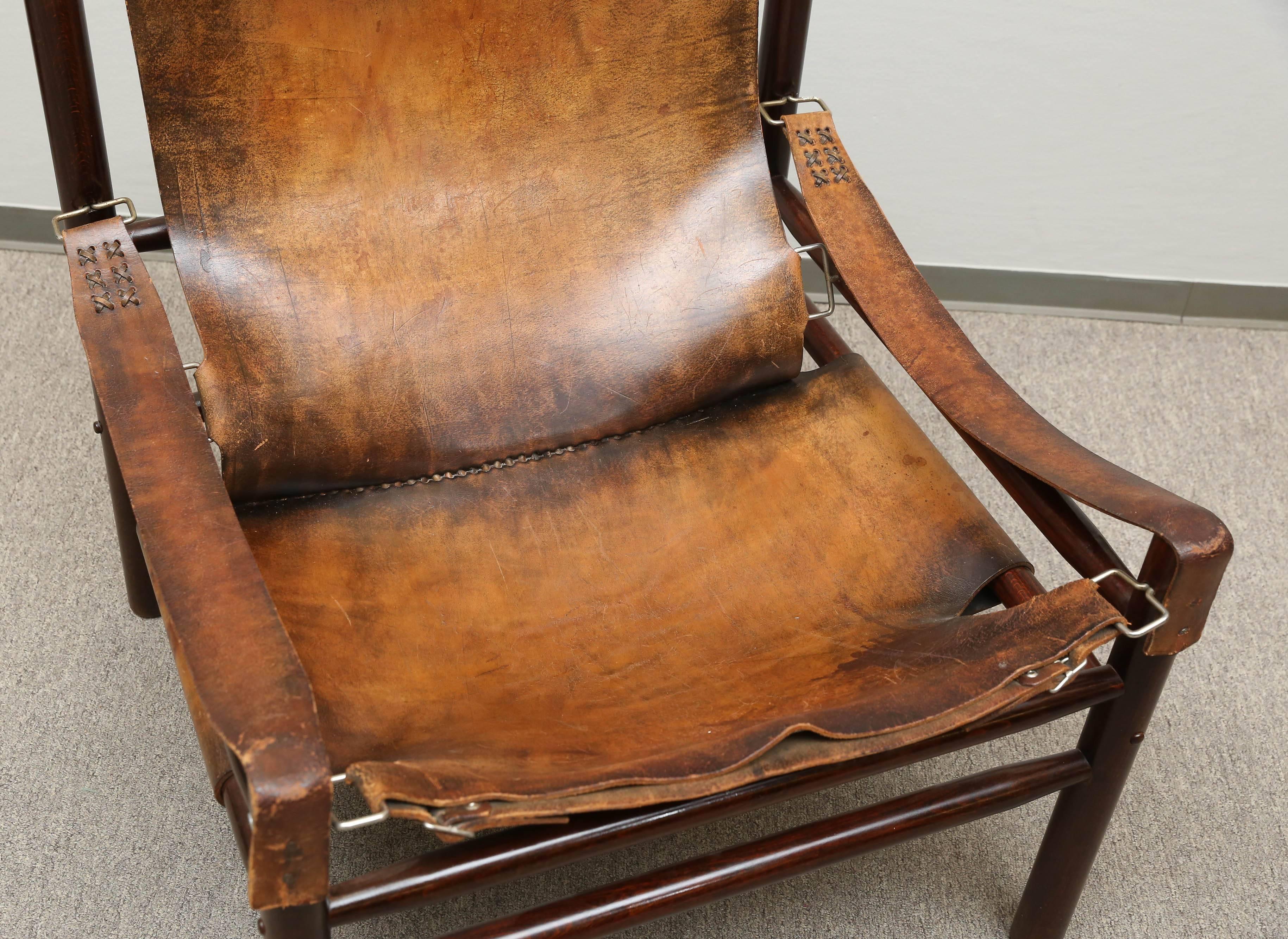 The wooden frame of this chair is attached to the stretched cow hide, that creates a sit and back of the chair. Armrests are created from a thin stripes of leather. 

Hungary, circa 1940s.

Measures: 28” x 28” x 32”.