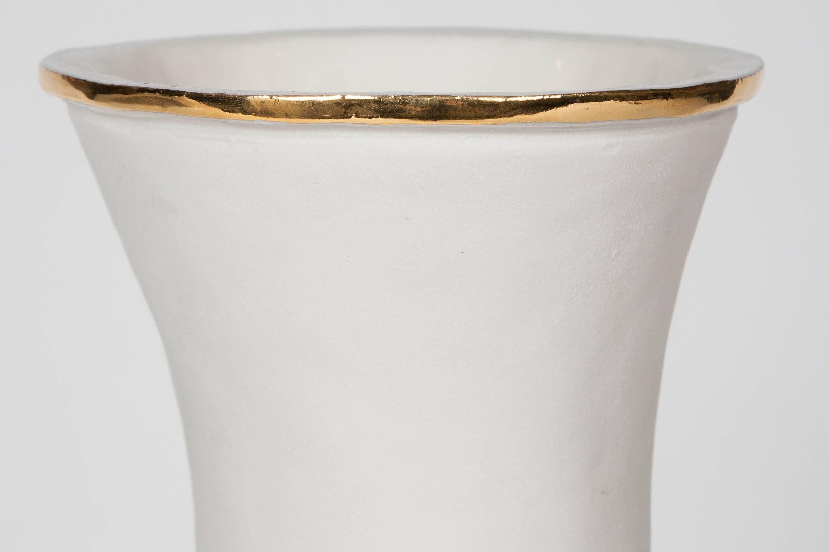 Hand coiled porcelain with parian flowers and gold lustre detail.

Working as ceramic artist, Hughes specialises in hand building, enjoying working with form and texture and studying its relation to decoration. Her practice is both fuelled by and