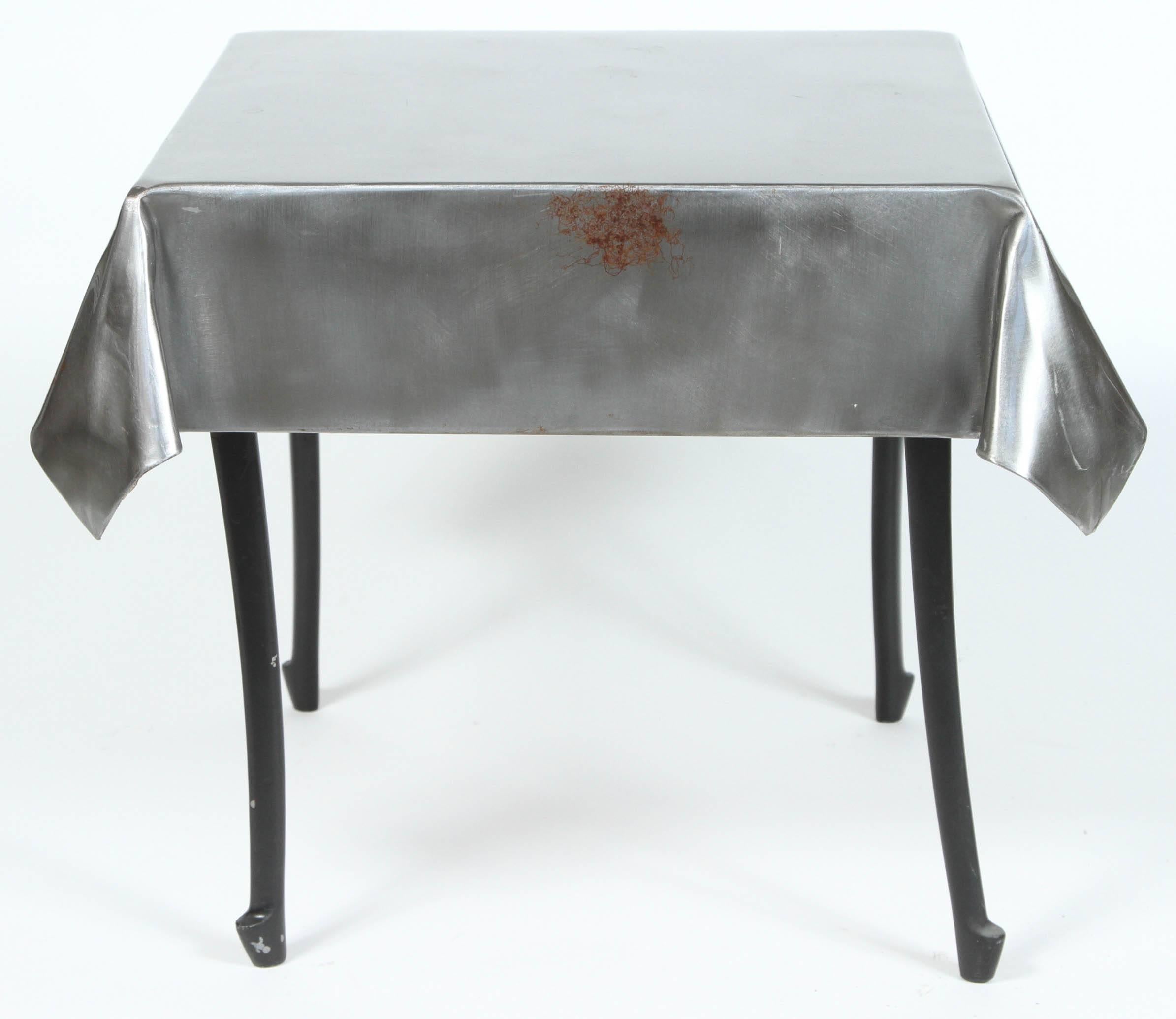 A pair of vintage steel end tables with “skirts” and cabriole legs.
