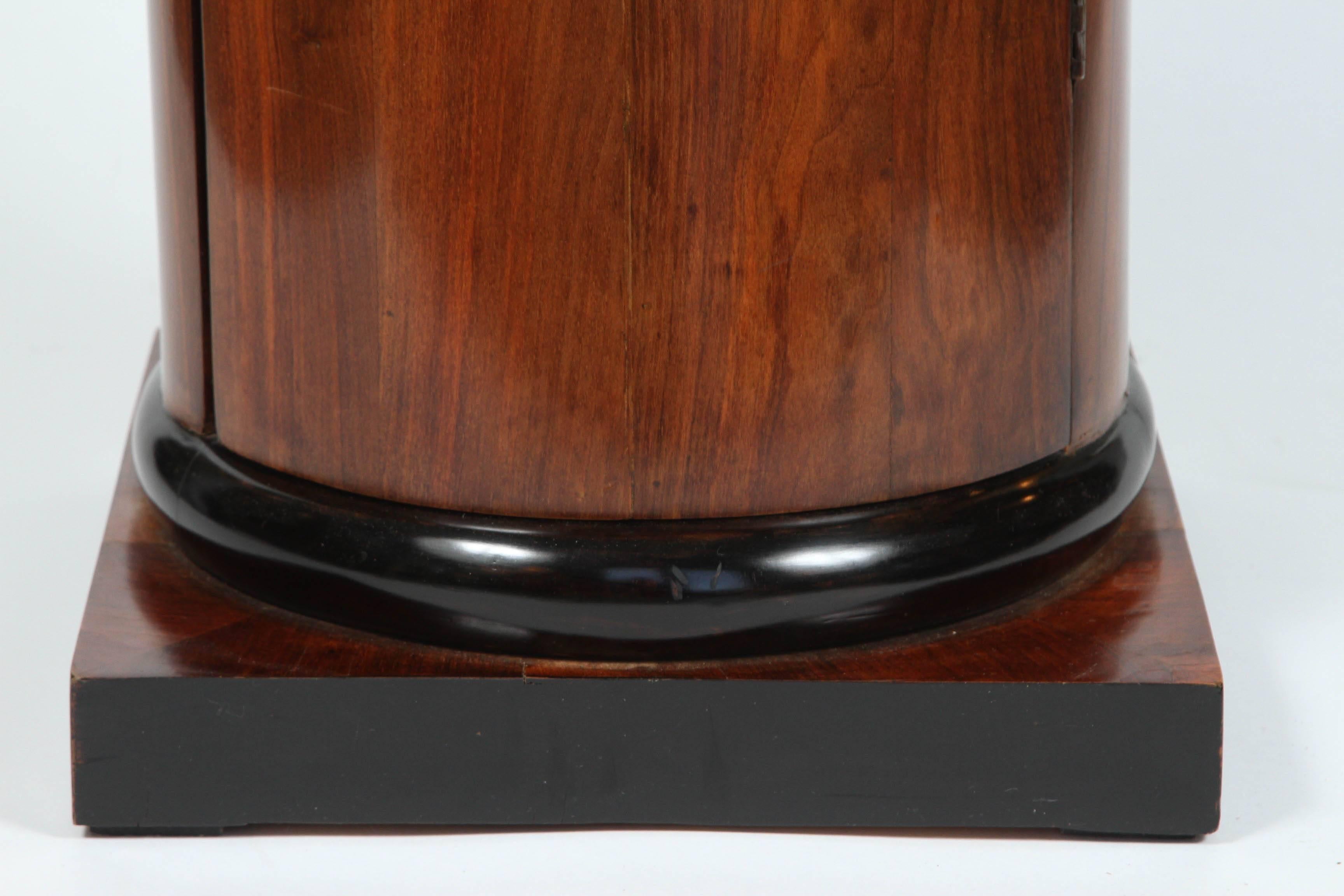 European A Walnut and Ebonized Wood Biedermeier Cylindrical Pedestal Cupboard