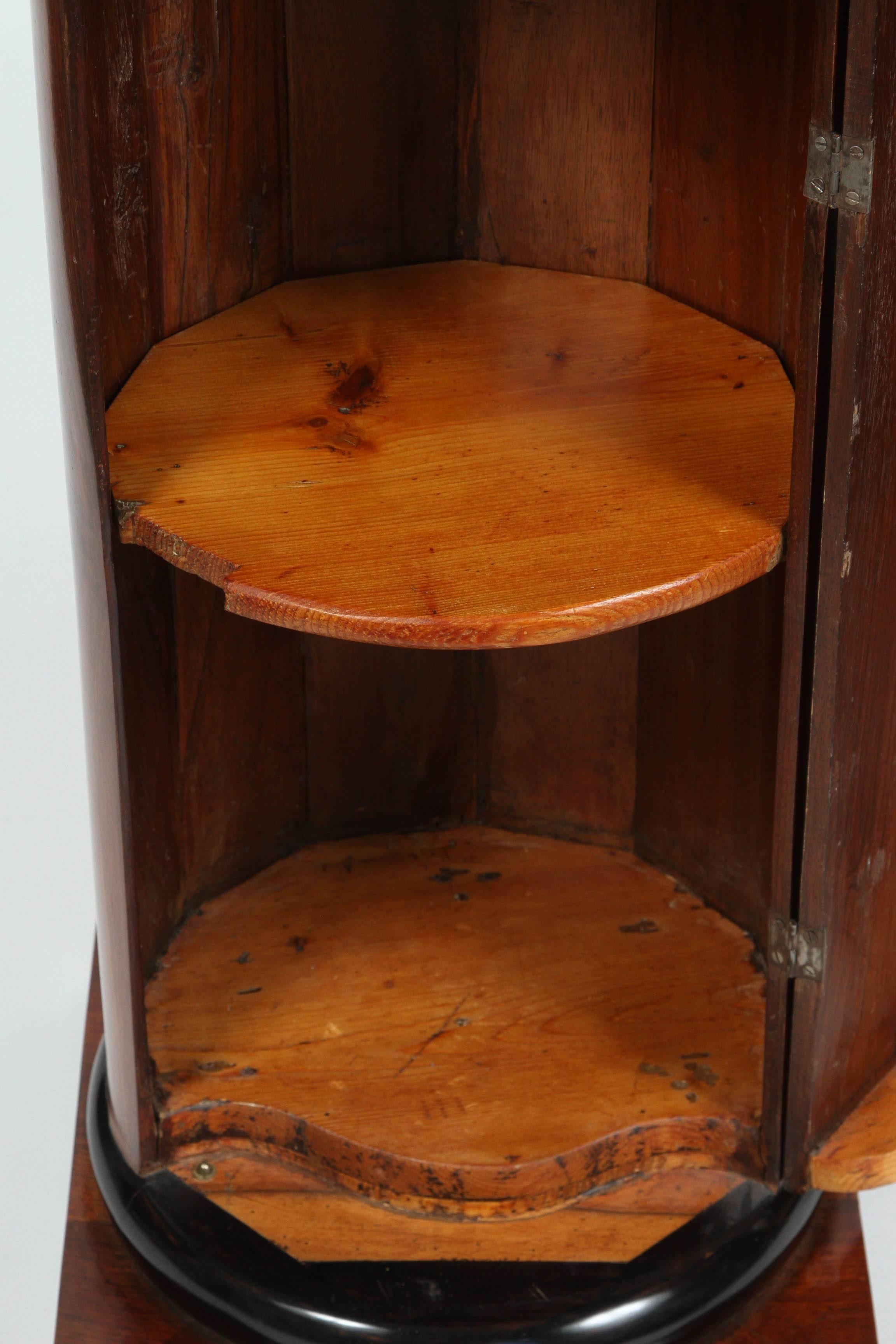 A Walnut and Ebonized Wood Biedermeier Cylindrical Pedestal Cupboard 1