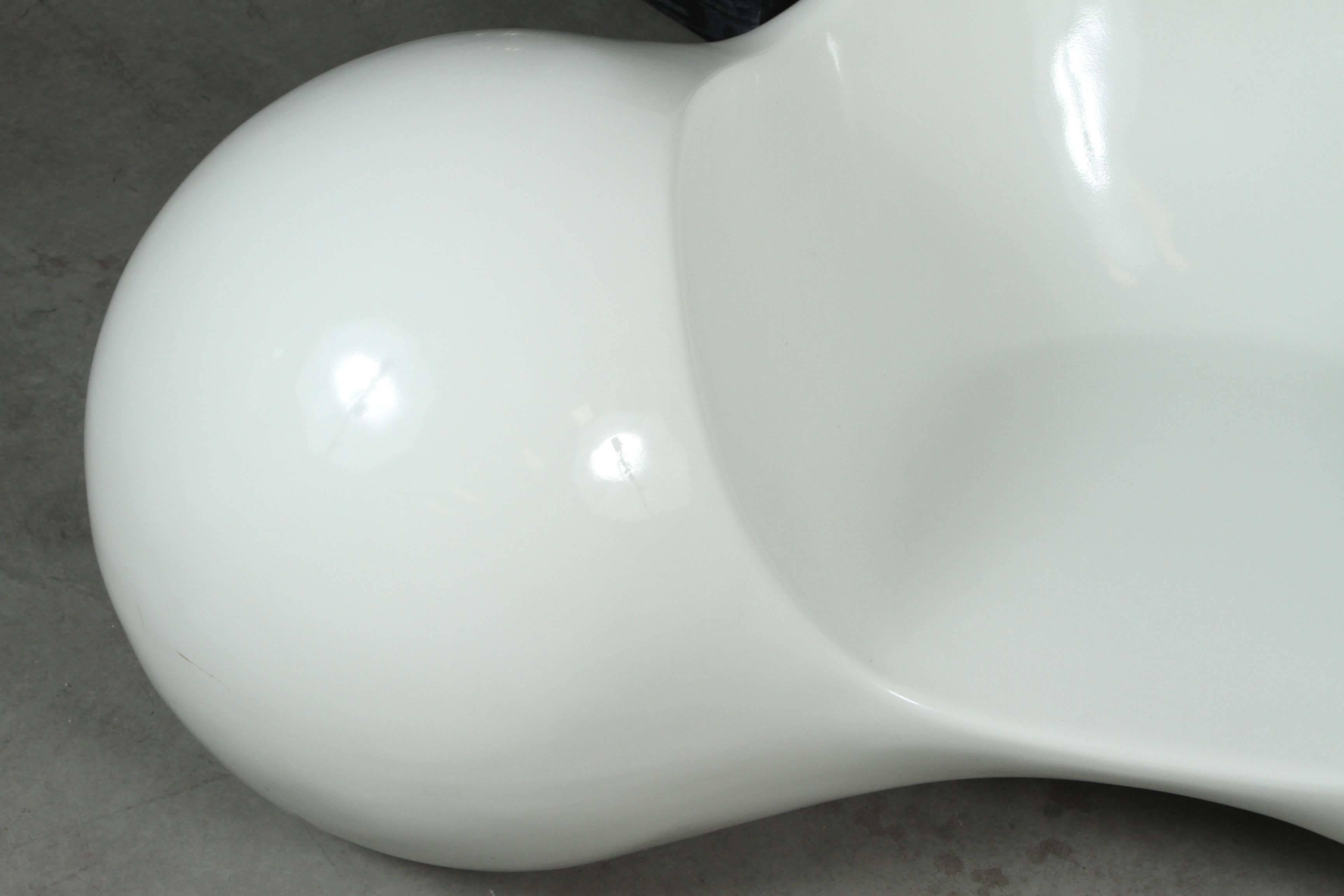 Iconic molded fiberglass chair by Eero Aarnio in white.