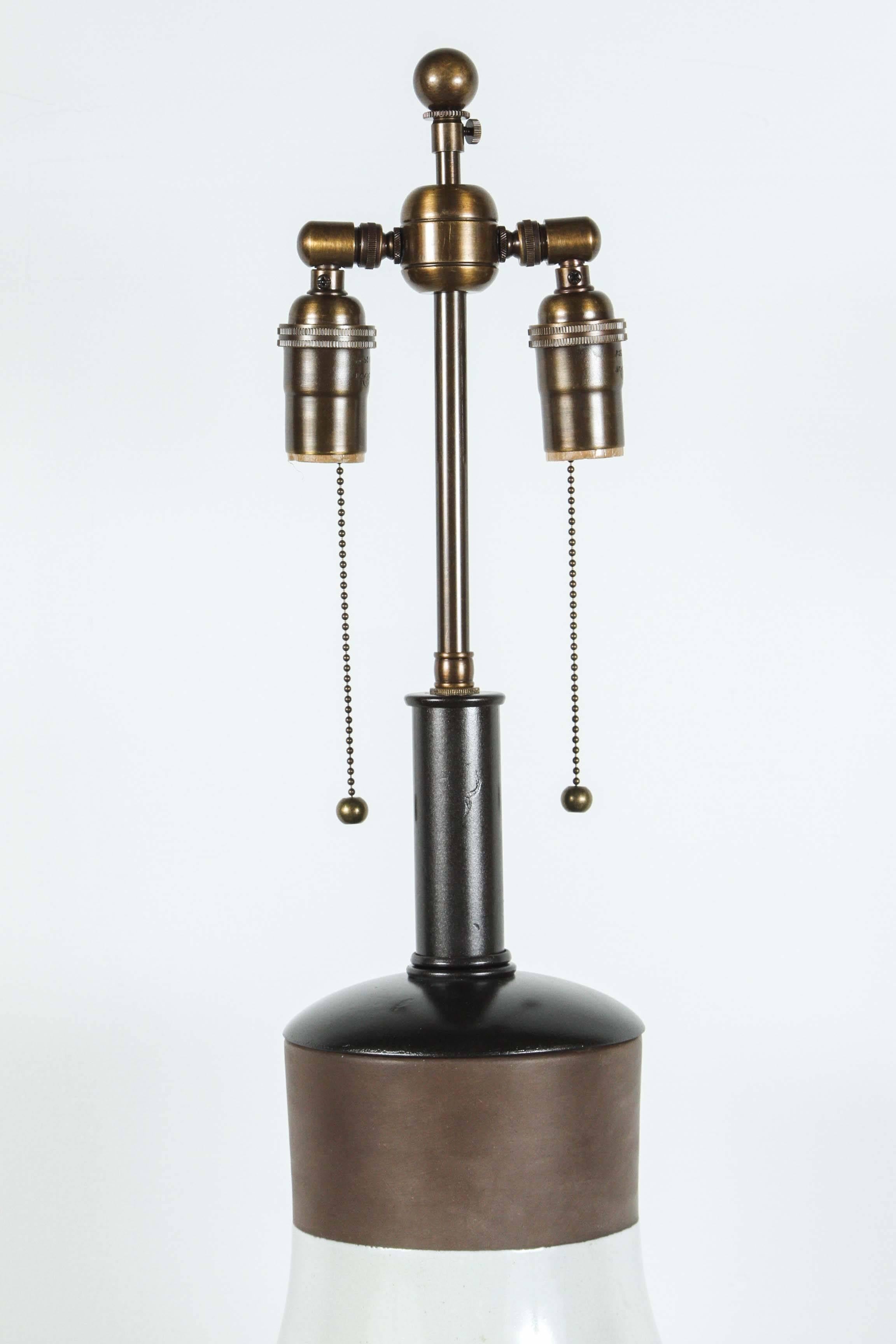 Fabulous large ceramic table lamp by Meiser of Switzerland. 
The ceramic has a raised decorative design, and is picked out with brown glaze. The lamp has been newly rewired with an antique bronze double cluster.