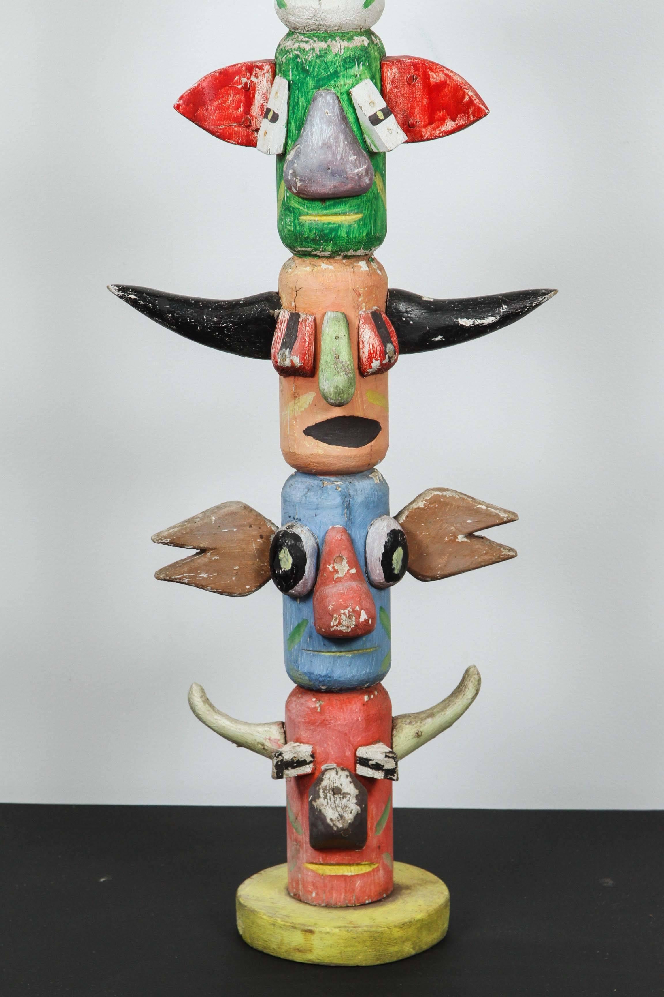 Midwestern United States hand-carved American Folk Art TOTEM pole found in Wisconsin, circa 1930s. Eight whimsical carved spirit animals with bright original paint surface.