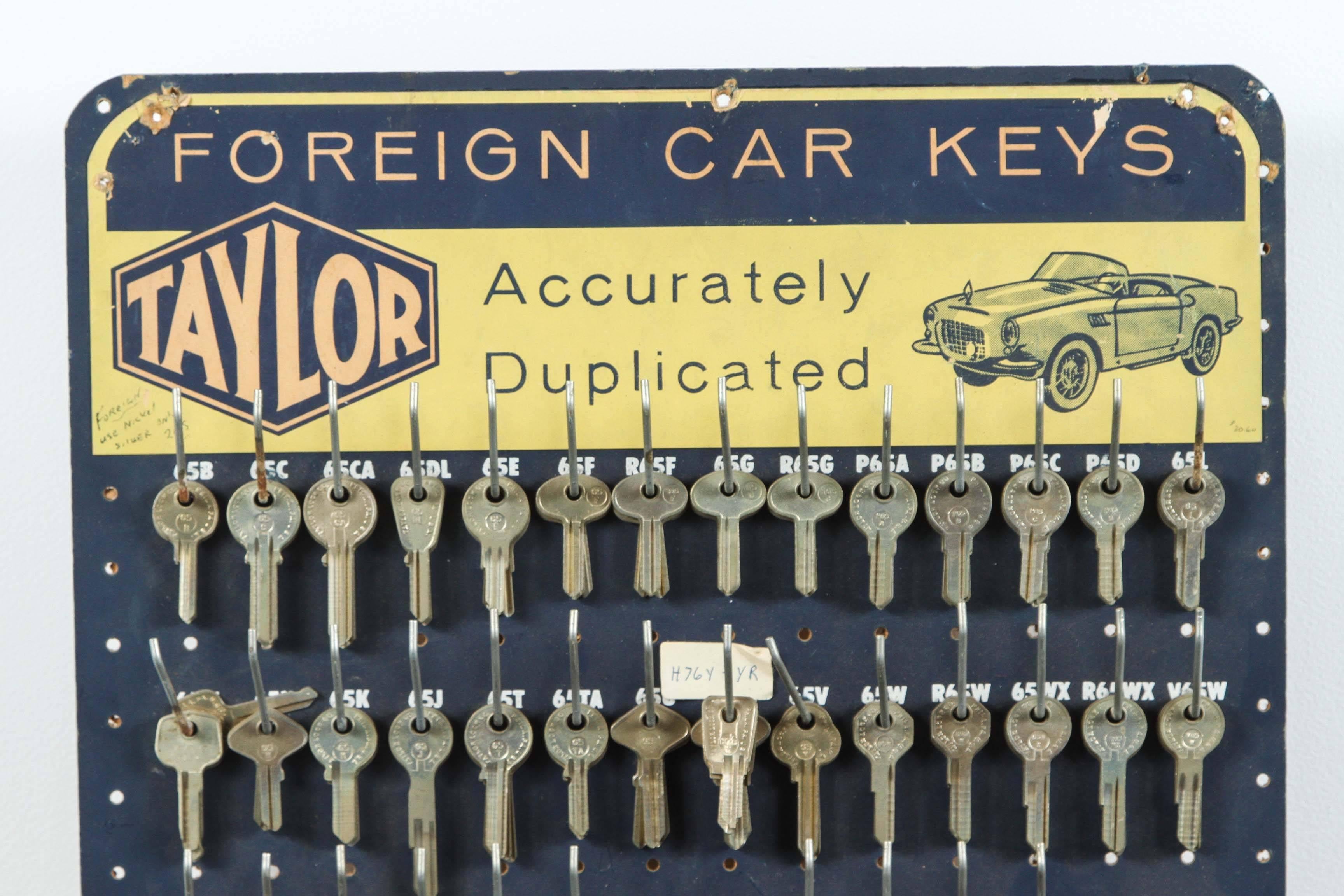 Manufactured by Taylor Key Company in Philadelphia for Mid-Century American hardware stores. Great obsessive and repetitive collection. Hooks mounted to peg board. Handwritten notes on board.