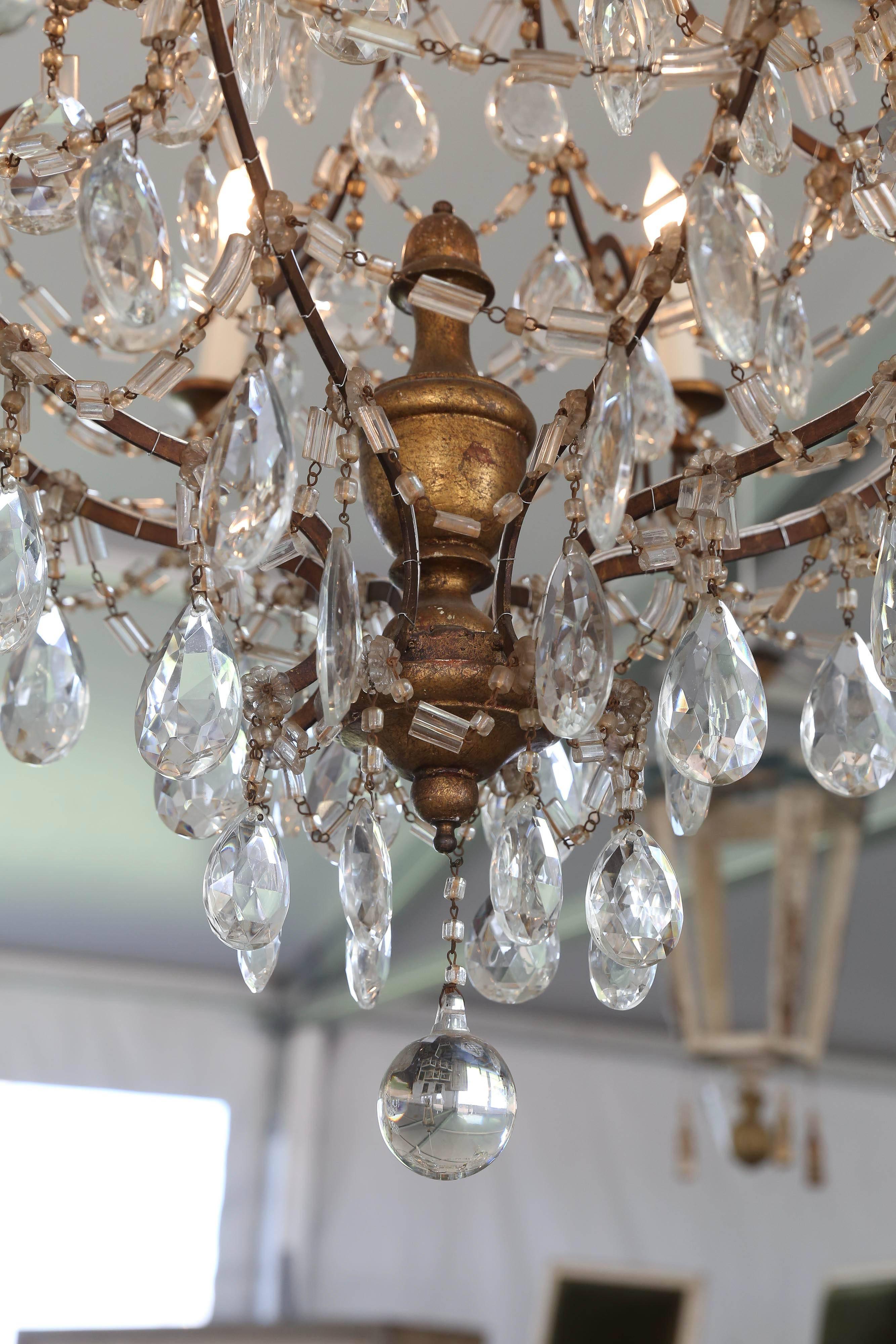 This very elegant crystal Genoa, Italy chandelier has gold giltwood housed in metal cage and draped in crystal.