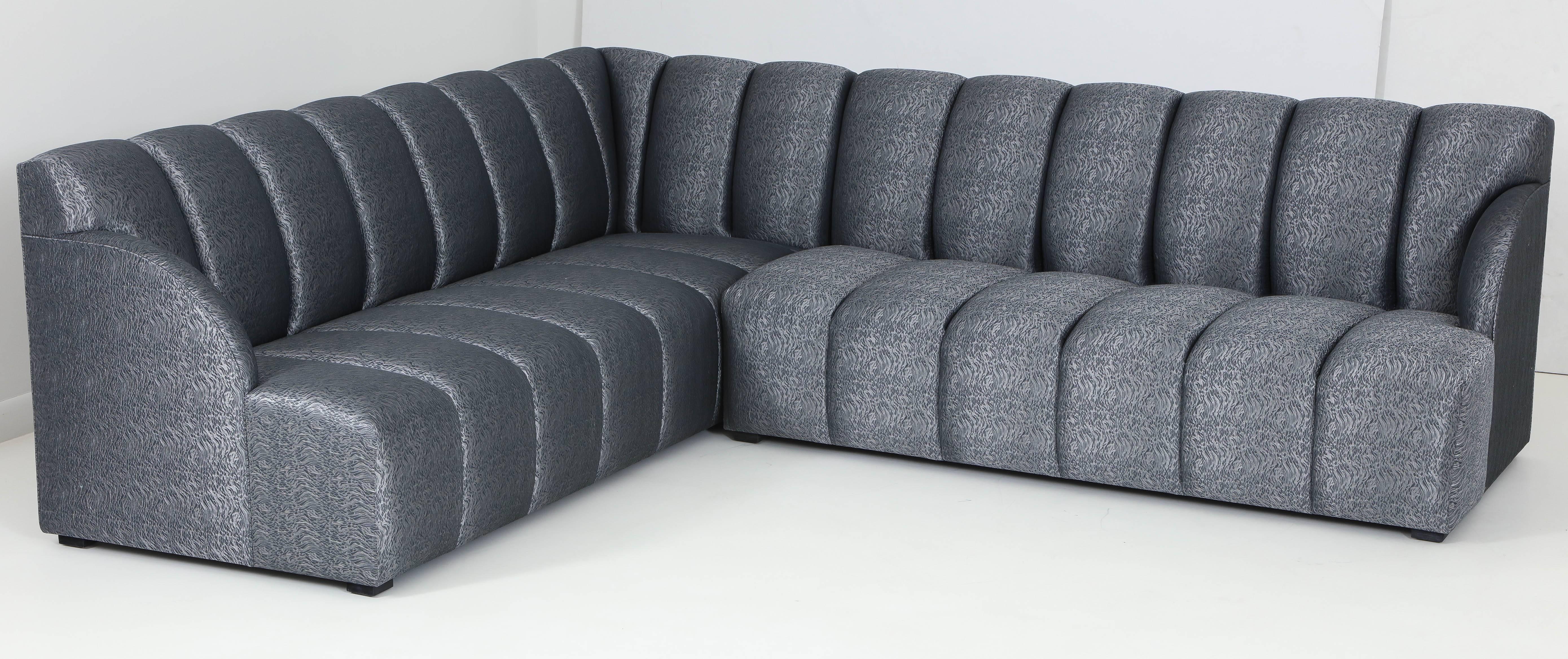 Modern channel tufted sectional sofa designed by iconic California designer Steve Chase. Sofa features new padding and upholstery from Romo which features grey/pewter metallic colors. Includes three pillows. 
Sofa measures 99