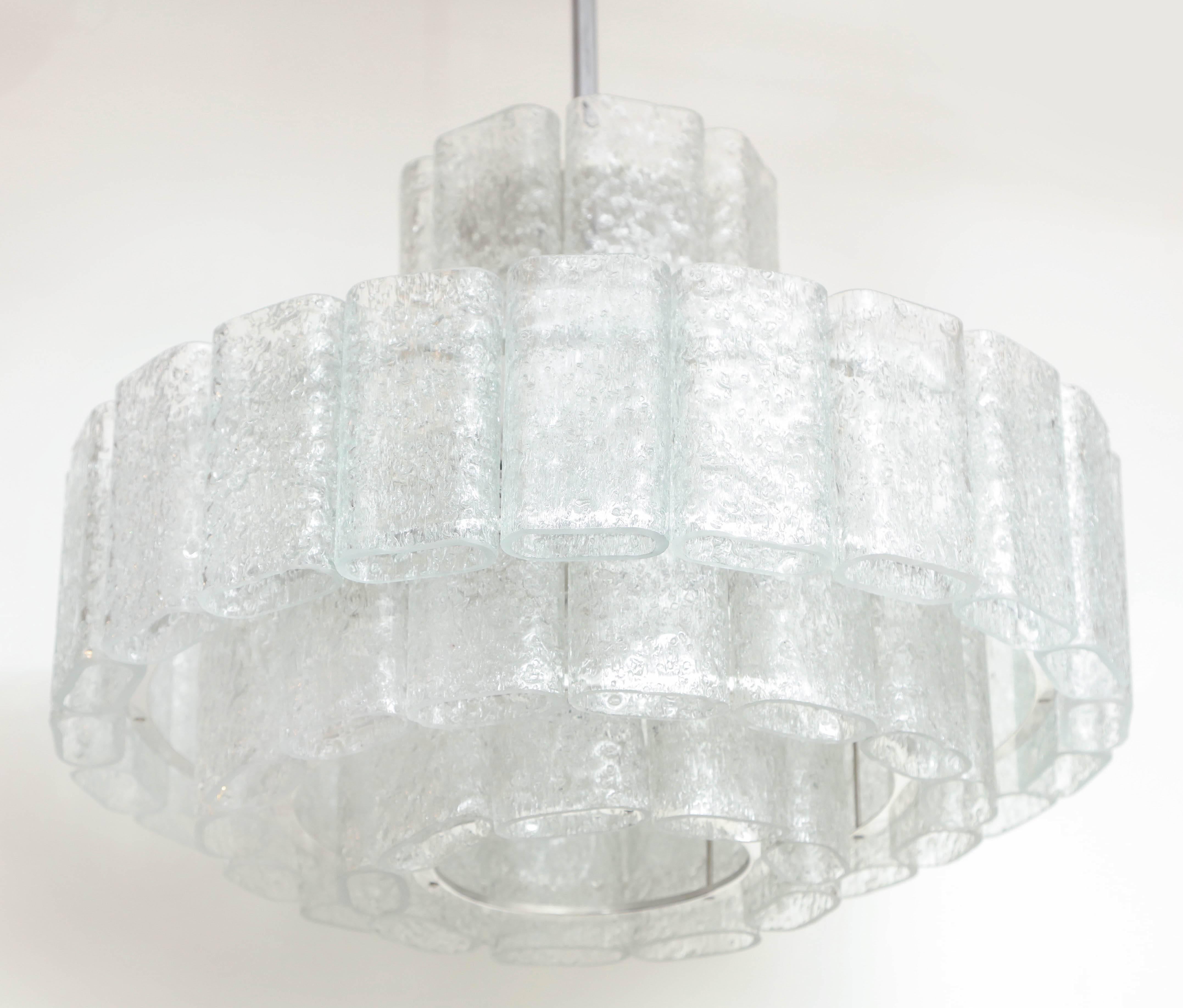 Modernist chandelier composed of four tiers of oblong shaped ice glass elements. Chandelier is suspended from a polished nickel stem and canopy. Rewired for use in the USA. Chandelier measures 31
