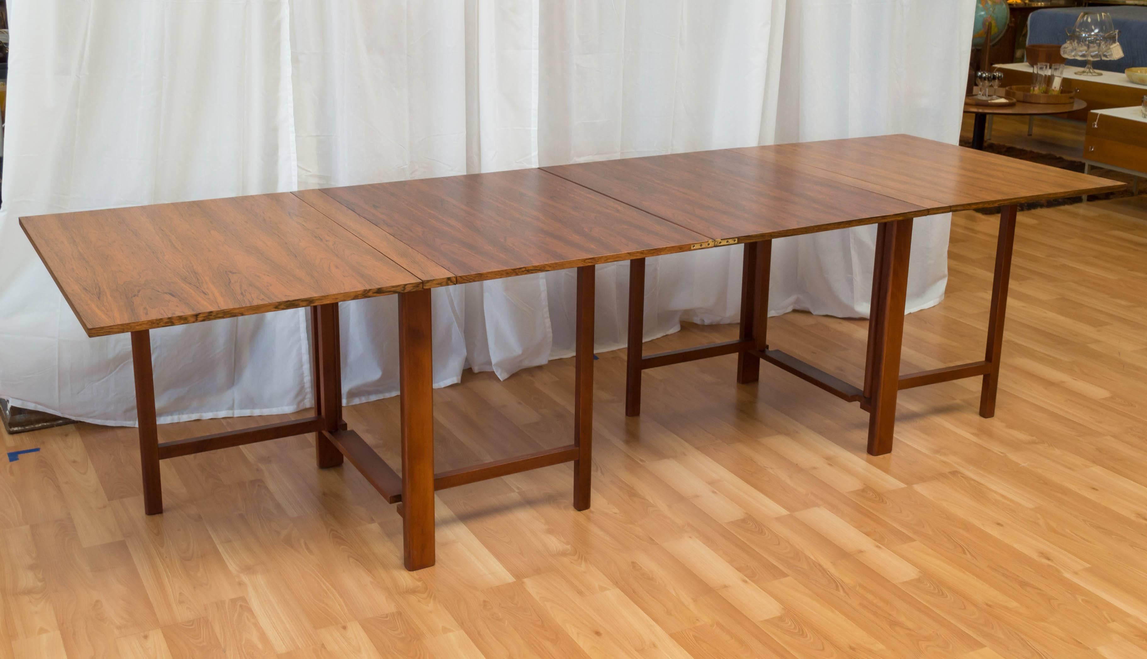 Purchased from the original owner, who said they bought it 40 plus years ago. Rosewood top, with Beech gate-legs. Expands nicely, you can seat two, to ten easily. If you need to store it out of the way it folds down to 9 inches wide. Two leaves up,