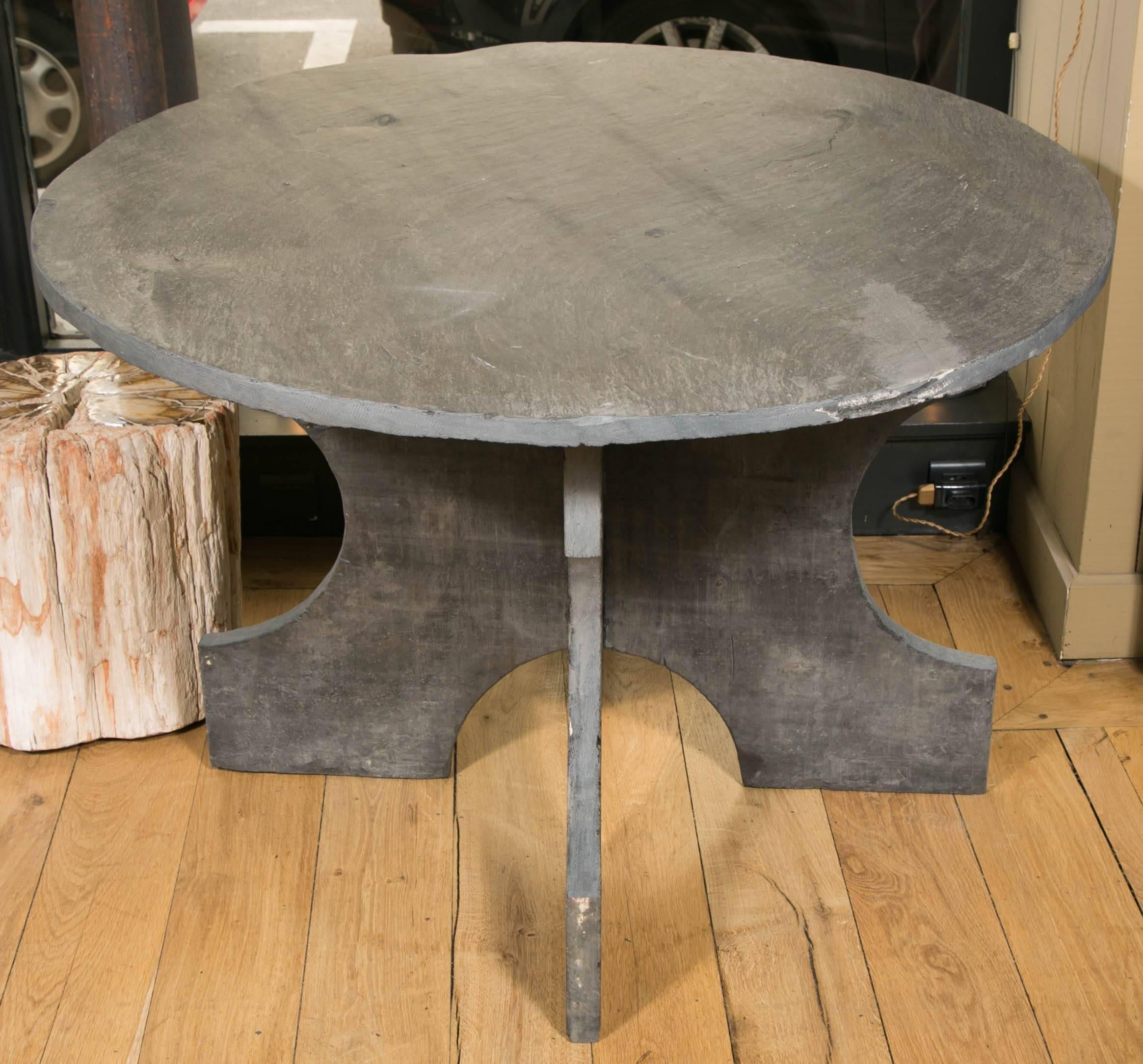 Central or dining table composed of three pieces of solid blue slate from North of France.
The table top was left with it's natural rough surface, simply polished but we can still appreciate deeps and asperities of the natural material.
The base