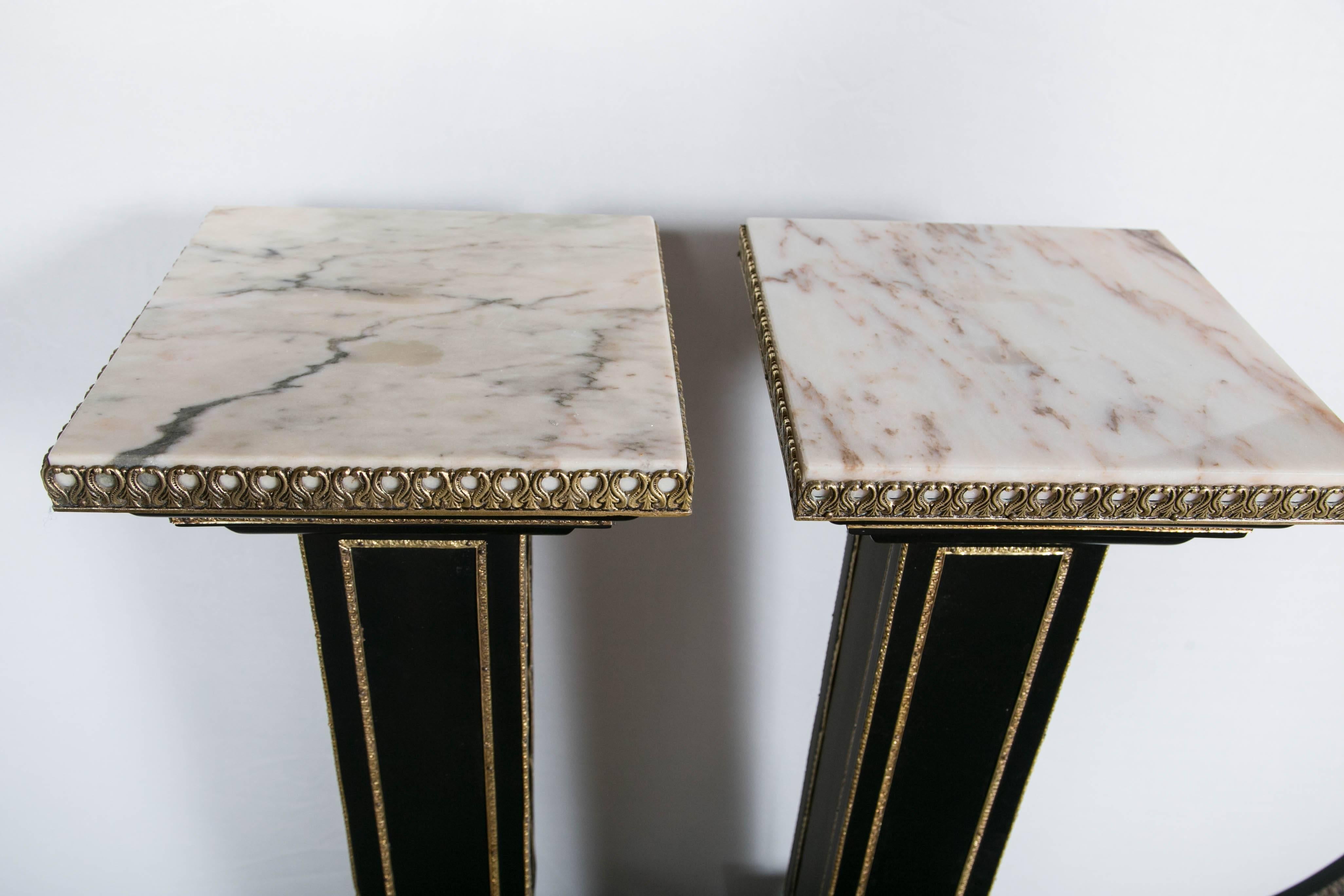 Maison Jansen, Hollywood Regency Pedestals, Ebonized Wood, Marble, Bronze, 1960s

Pair of bronze-mounted ebonized pedestals by Maison Jansen. Each having a square base on capped corner feet with bronze leaf decorations and bronze corners adorning an