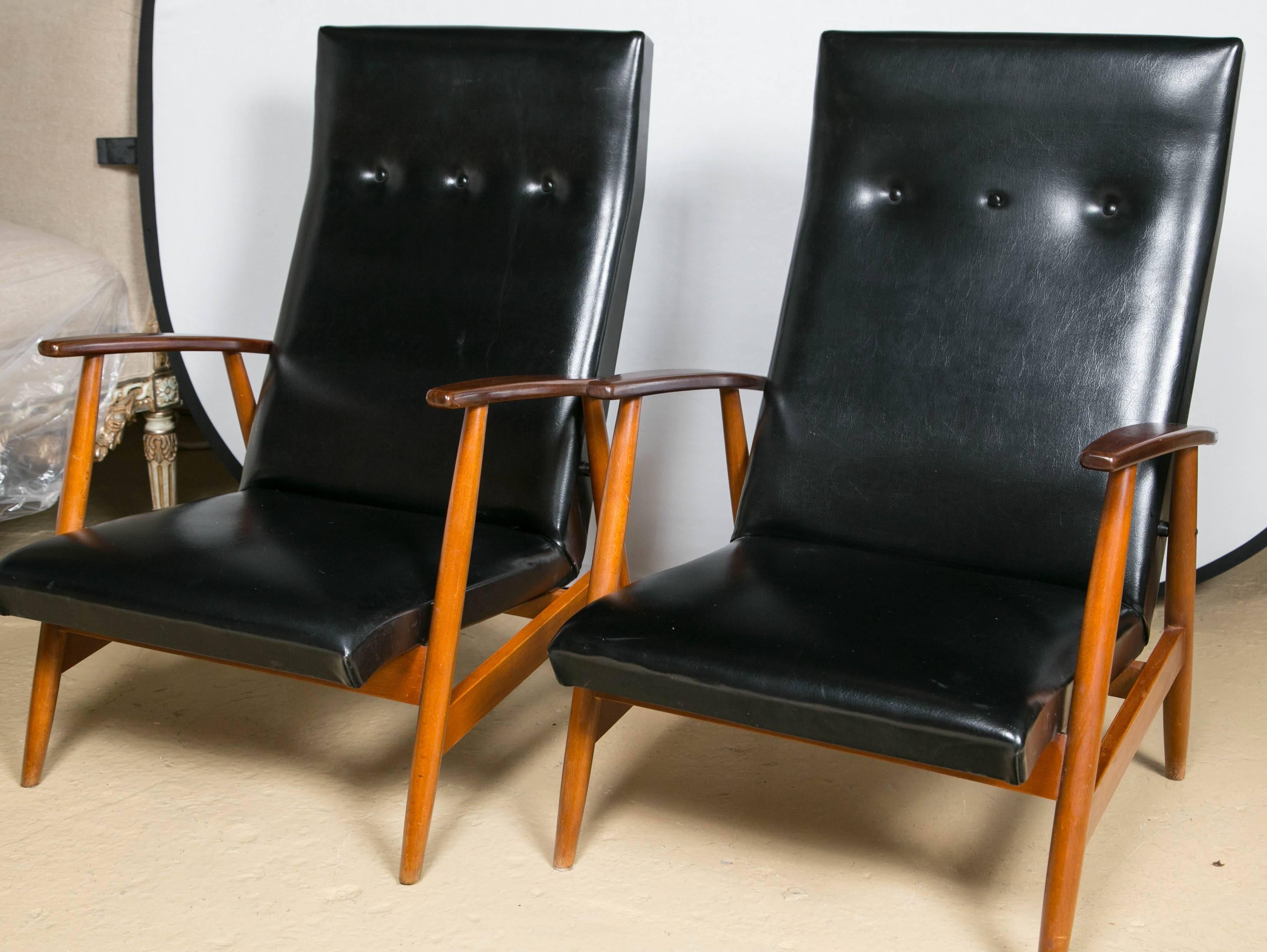 Pair of Scandinavian teak and black lounge chairs. Simplicity at its finest. This custom quality pair of lounge chairs has a wonderfully refined Mid-Century Modern look and design. The wood frames recently had rubbed French polished to a modest