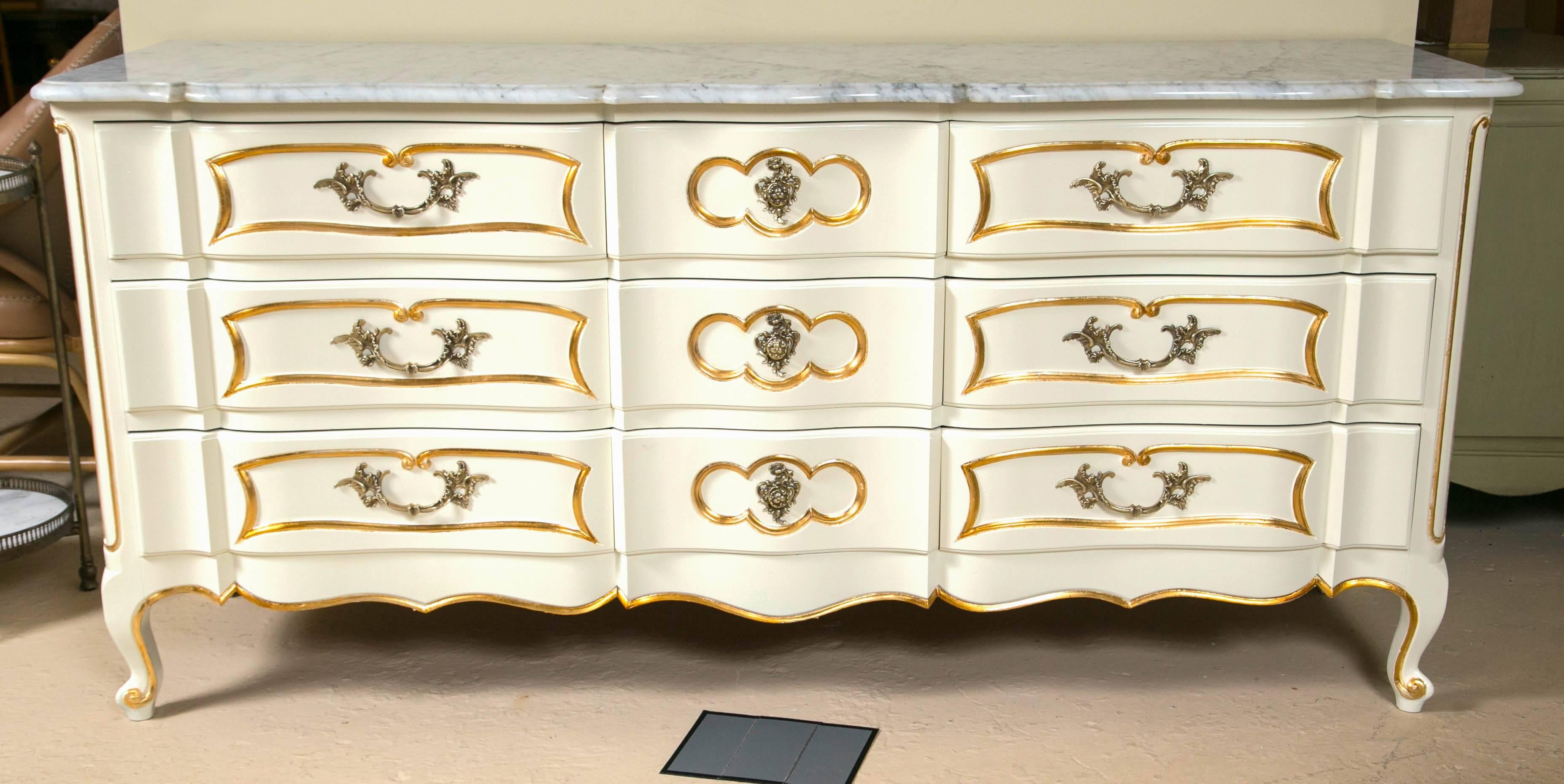 Louis XV style marble top painted and gilt decorated dresser commode. This fabulous nine-drawer dresser has an oak secondary case in the Louis XV style that has been primed and finely painted. The three center small drawers flanked by wider deep