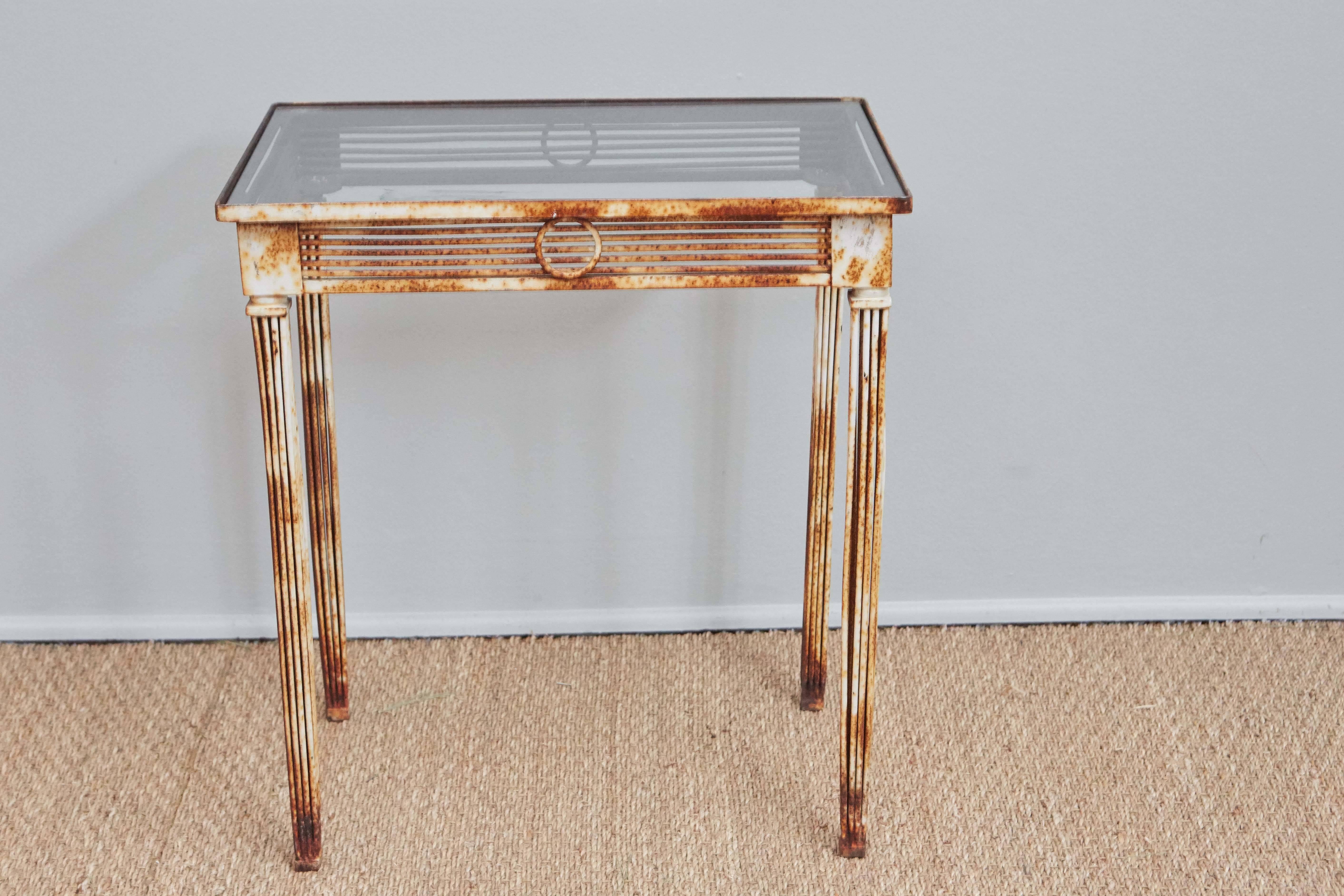 Original white paint rusted through. Glass top. Modernist take on neoclassical style. Measures: 20 W x 14 D 22 H.