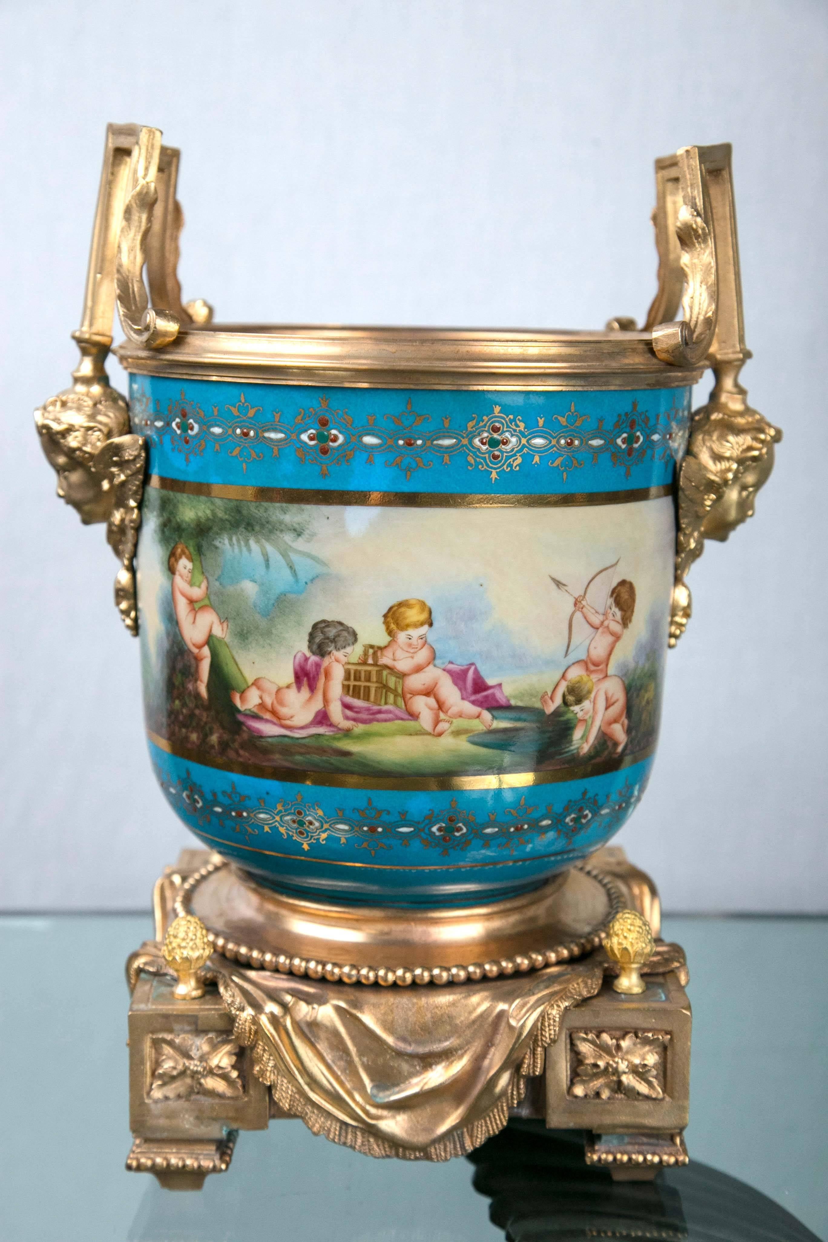 Each cache pot with gilt bronze bases and handles with winged putti heads.

The porcelain of 