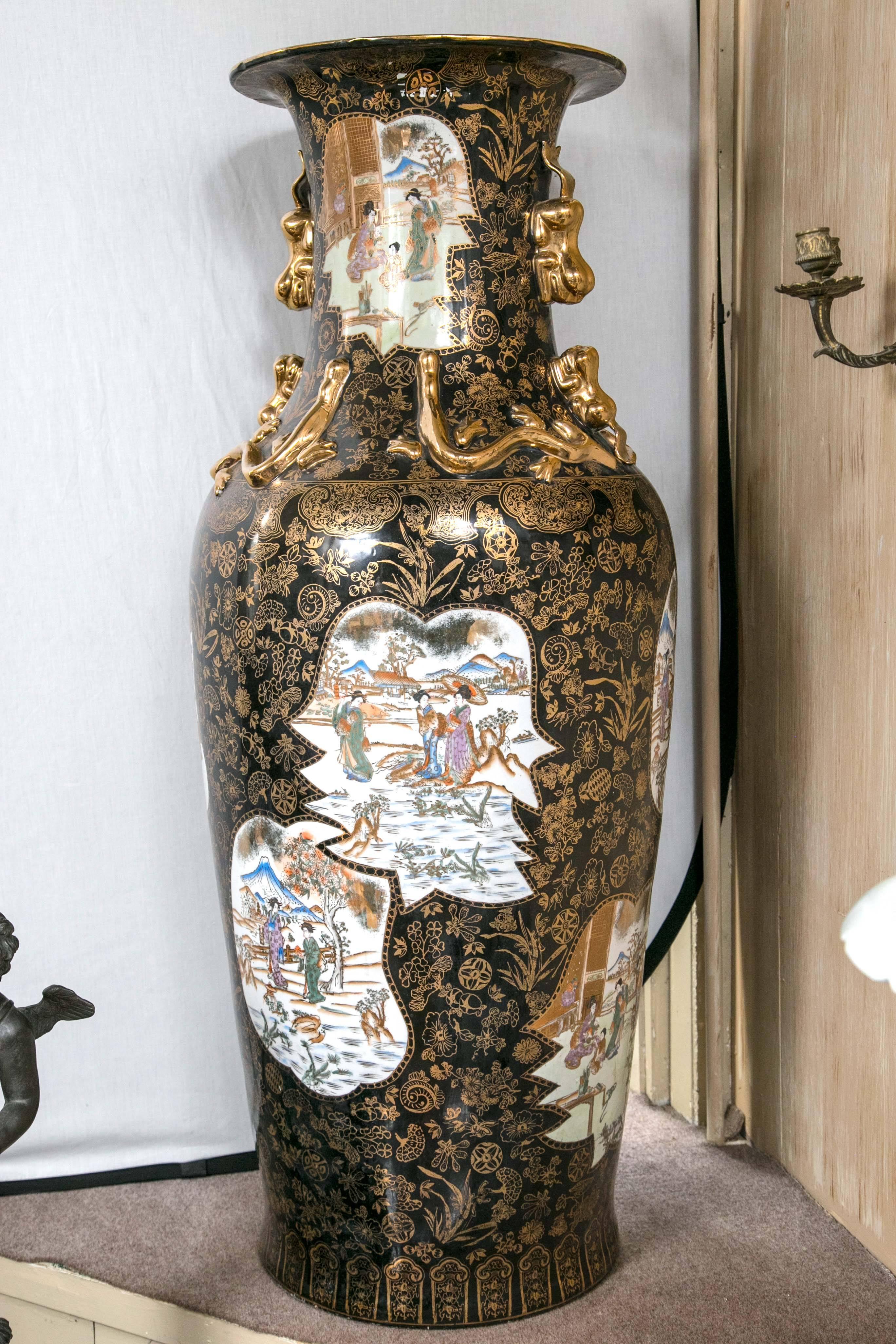 Standing 52 inches tall this pair is decorated with painted plaques in a black and gold ground. Gilded foo dogs and dragons decorate the neck.
Diameter of 22