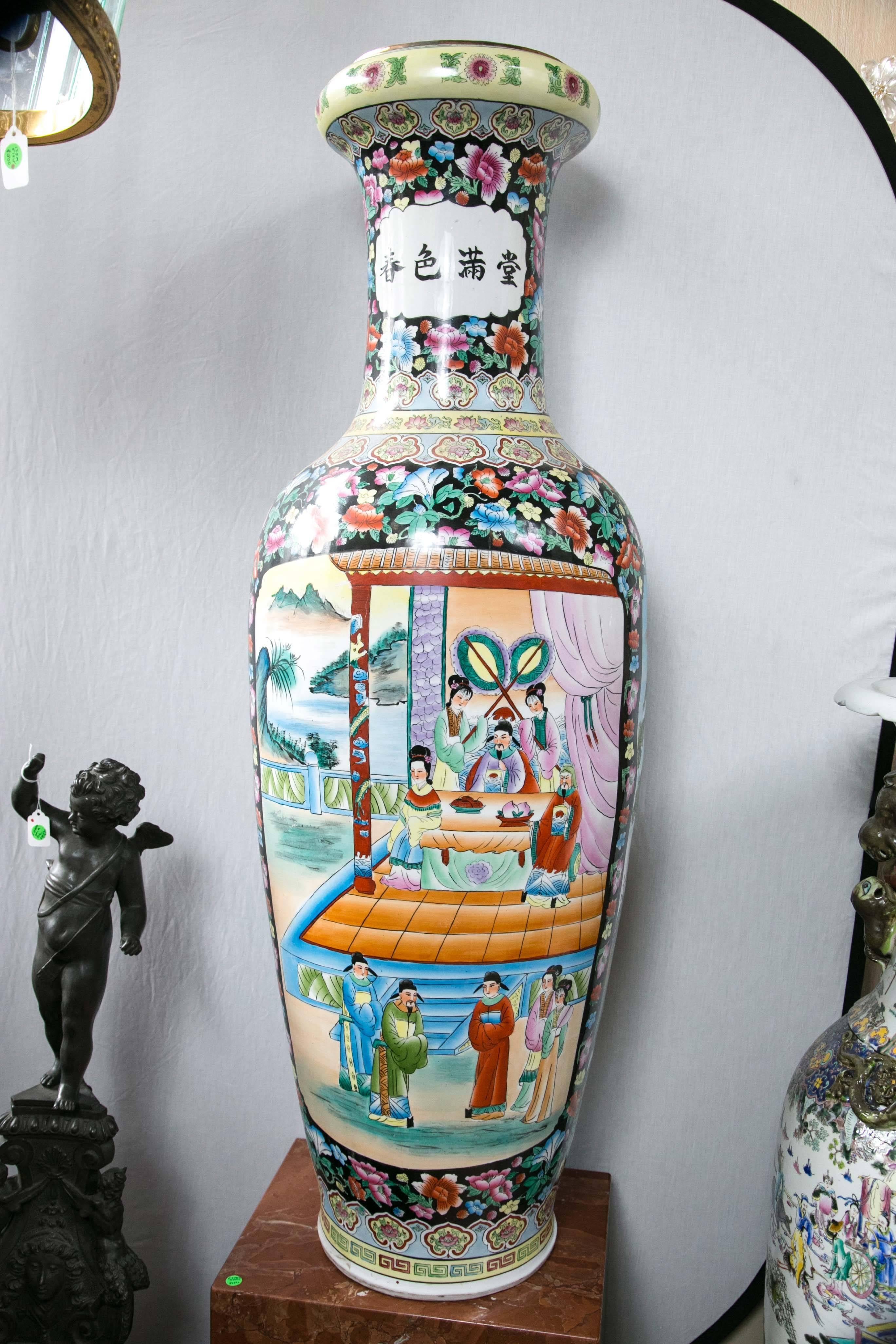 This pair have a Famille noire ground decorated with floral motifs. Each has two panels of painted figures in court settings.
Chinese calligraphy decorates the necks.