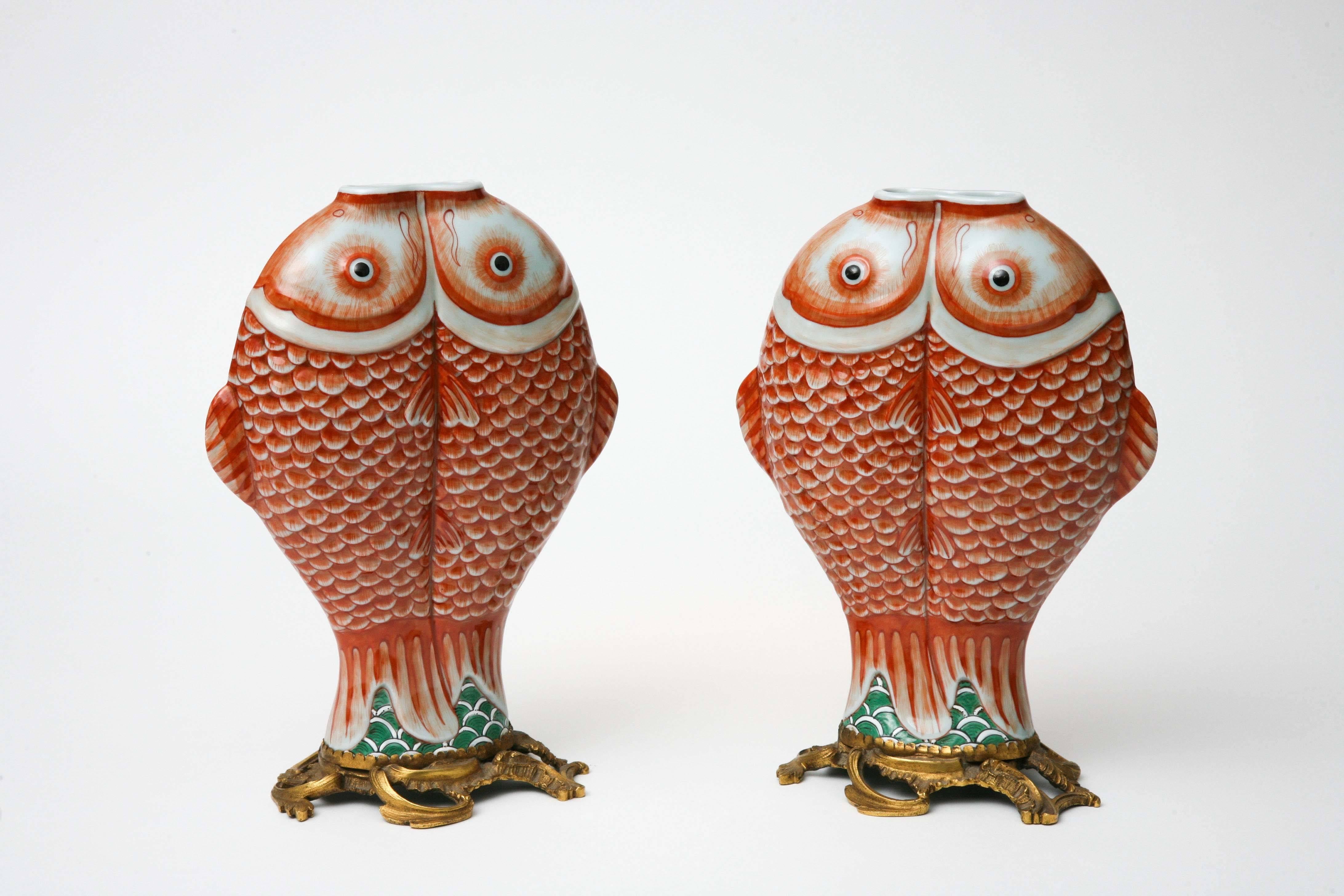 These Qing dynasty (1662-1722) Chinese porcelain vases are in the form of double carp, a symbol of bounty and good luck, popular in mid-18th century France because of their exotic oriental design. Imported from China they were then mounted on French