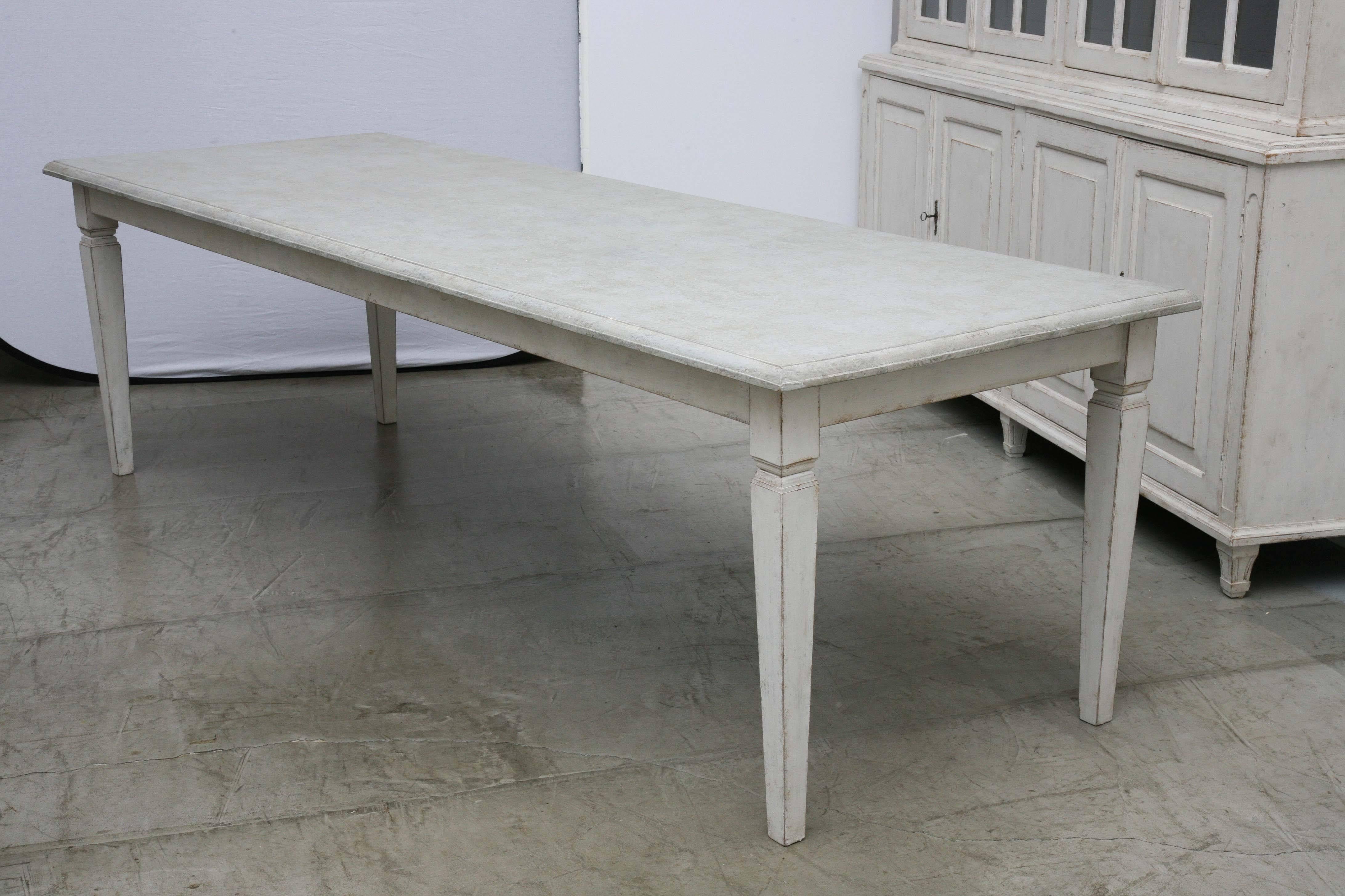 Antique long Swedish Painted dining farm table with a beautiful patina.
The table top in a painted distressed gray color with a carved ogee edge and the bottom in light Gustavian white-tray painted distressed finish,  square tapered simple legs.