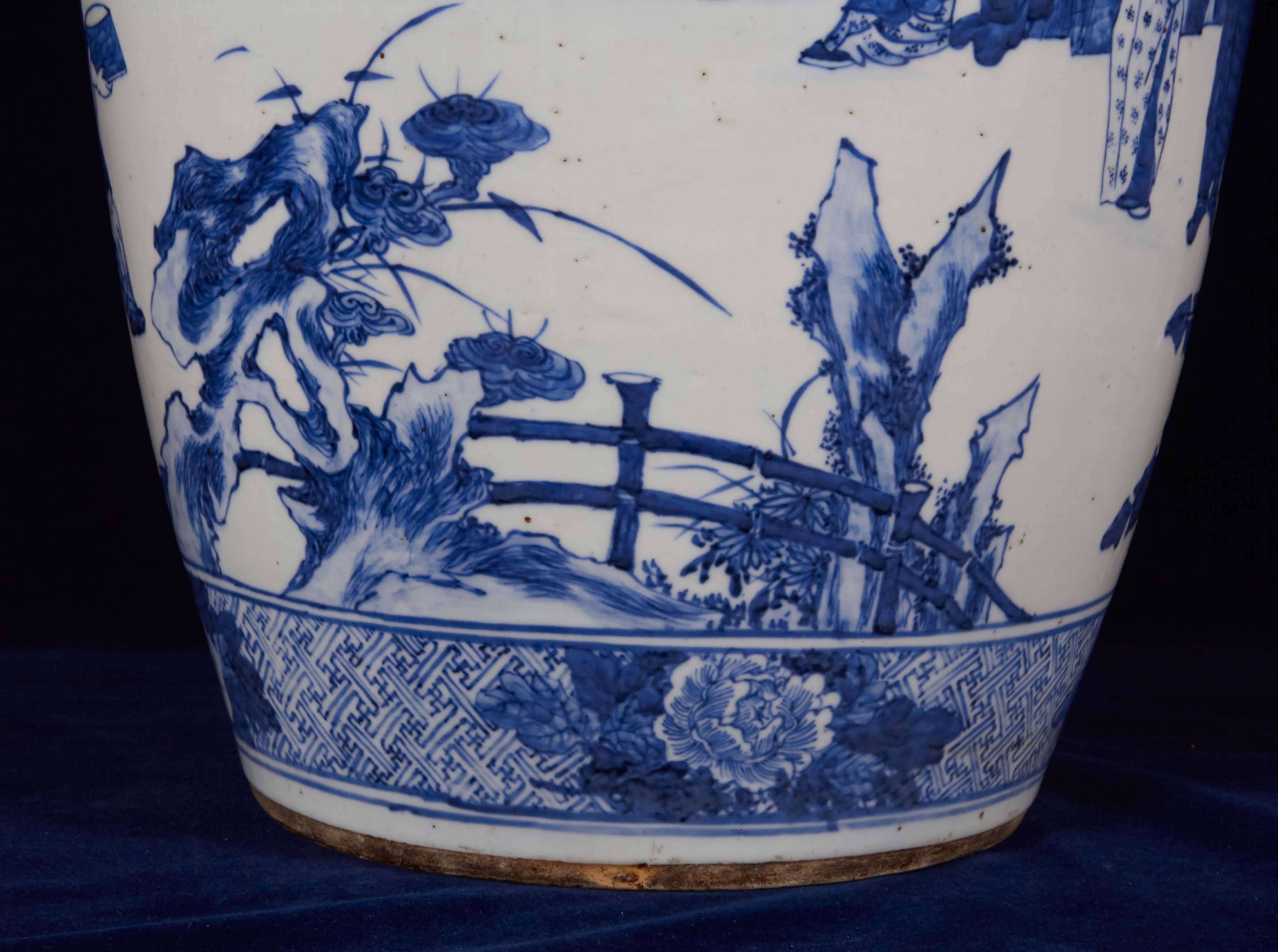 A large Chinese porcelain figural blue and white vase.
19th century, signed on the underside with characters in black ink.
Ovoid with flared mouth, finely painted with a continuous scene of court figures performing a tea ceremony and ladies
