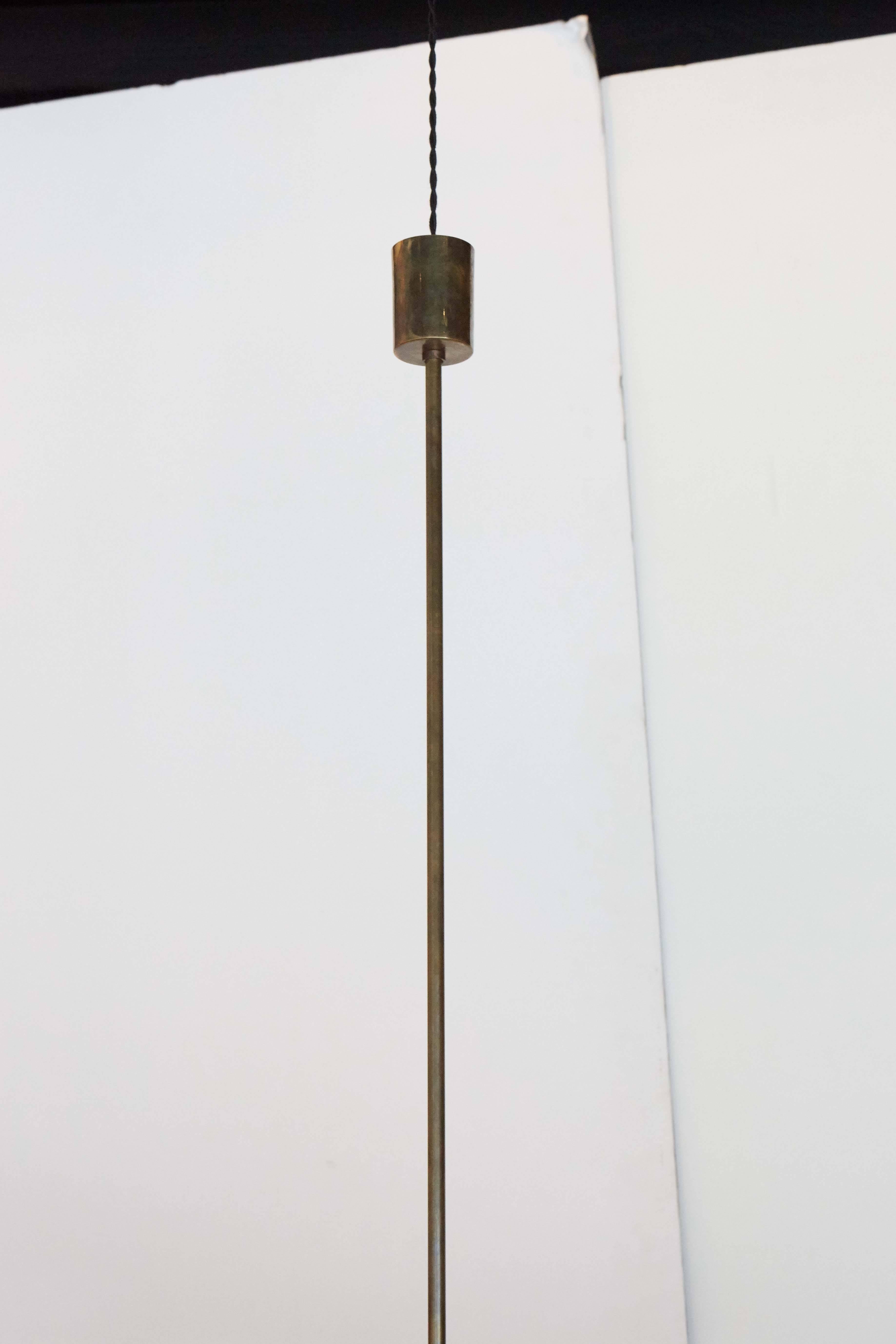 A brass and enameled metal / aluminum ceiling pendant.
Has been rewired for safety.